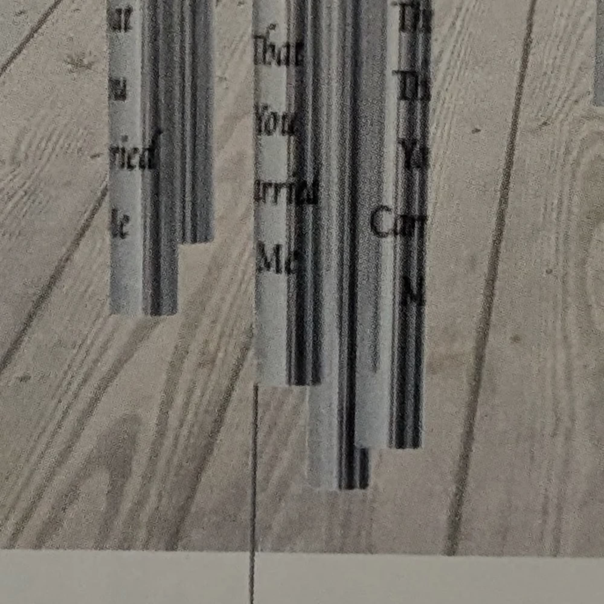 Hanging silver wind chime with wooden accents and an oval footplate