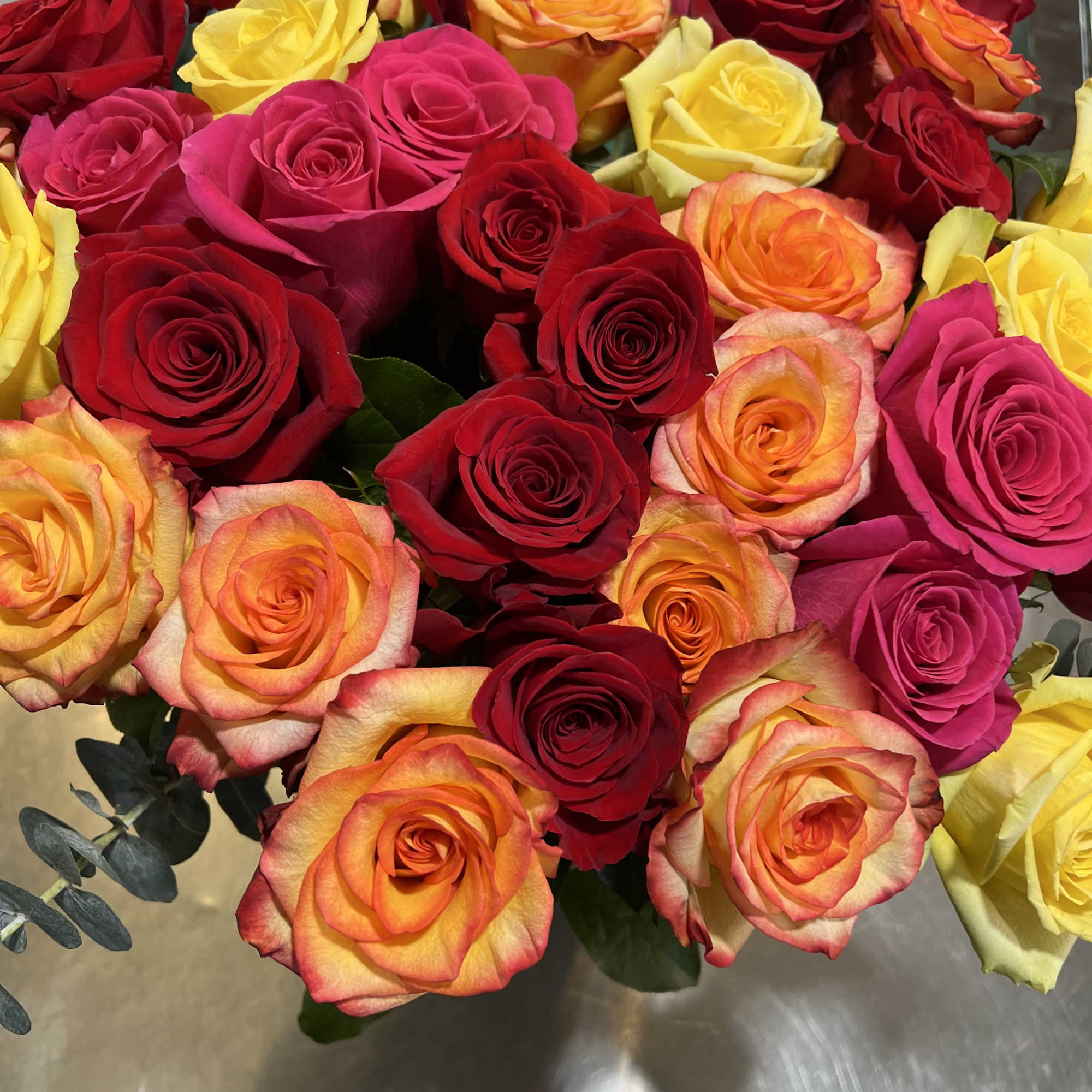 Bouquet of multicolored roses in red, pink, yellow, and orange