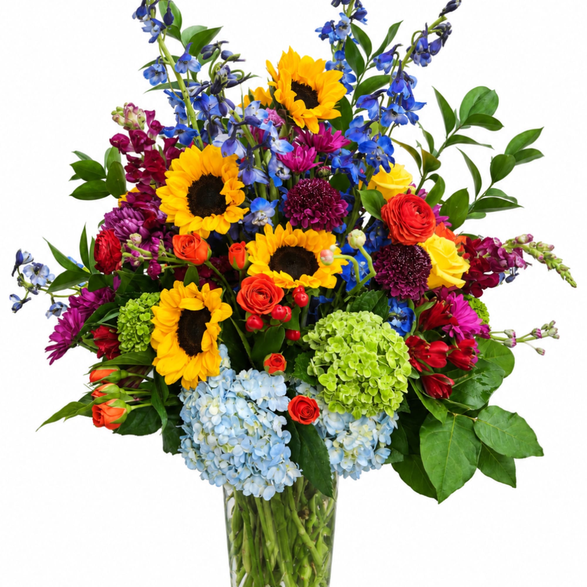 Colorful bouquet with sunflowers, roses, hydrangeas, and blue flowers in a glass vase