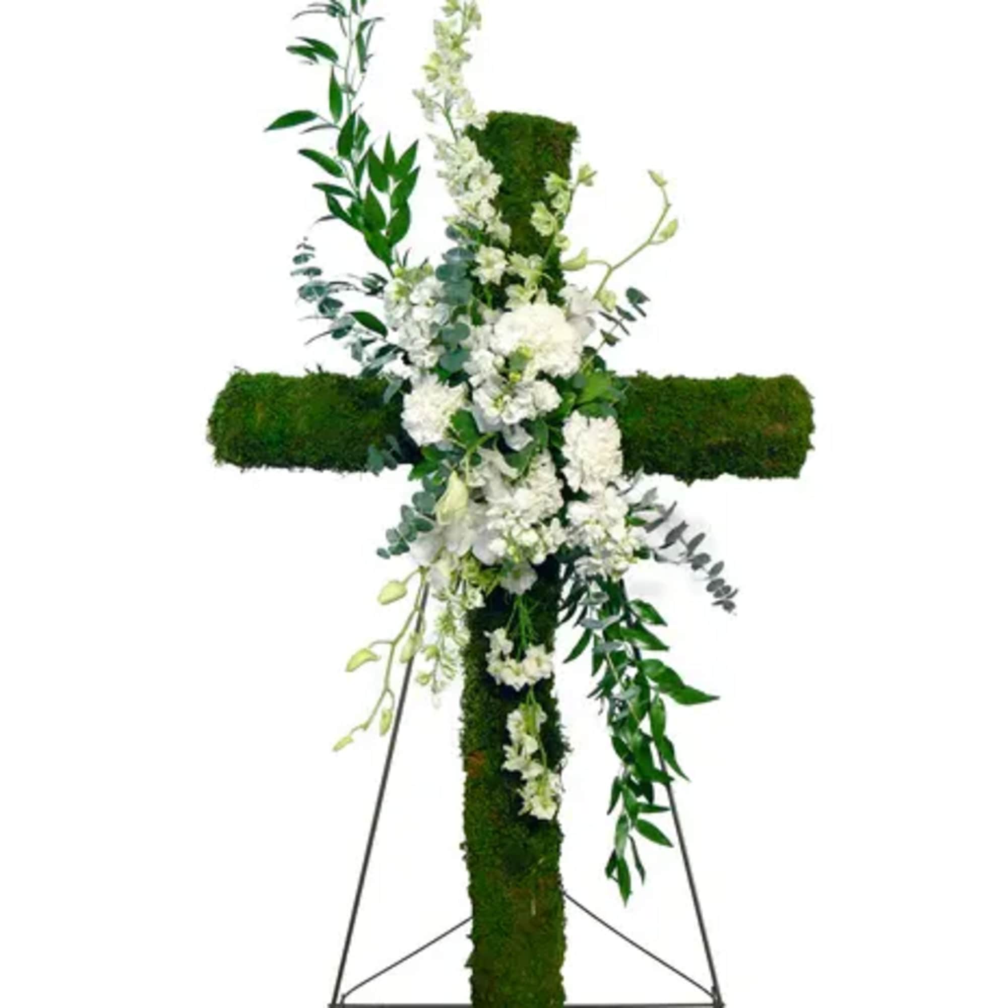 White floral cross on a stand with trailing greenery