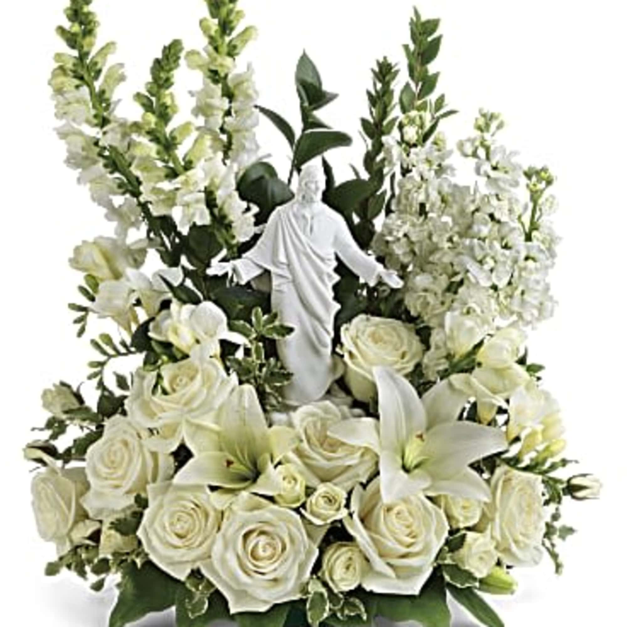 White floral arrangement with a small statue in the center