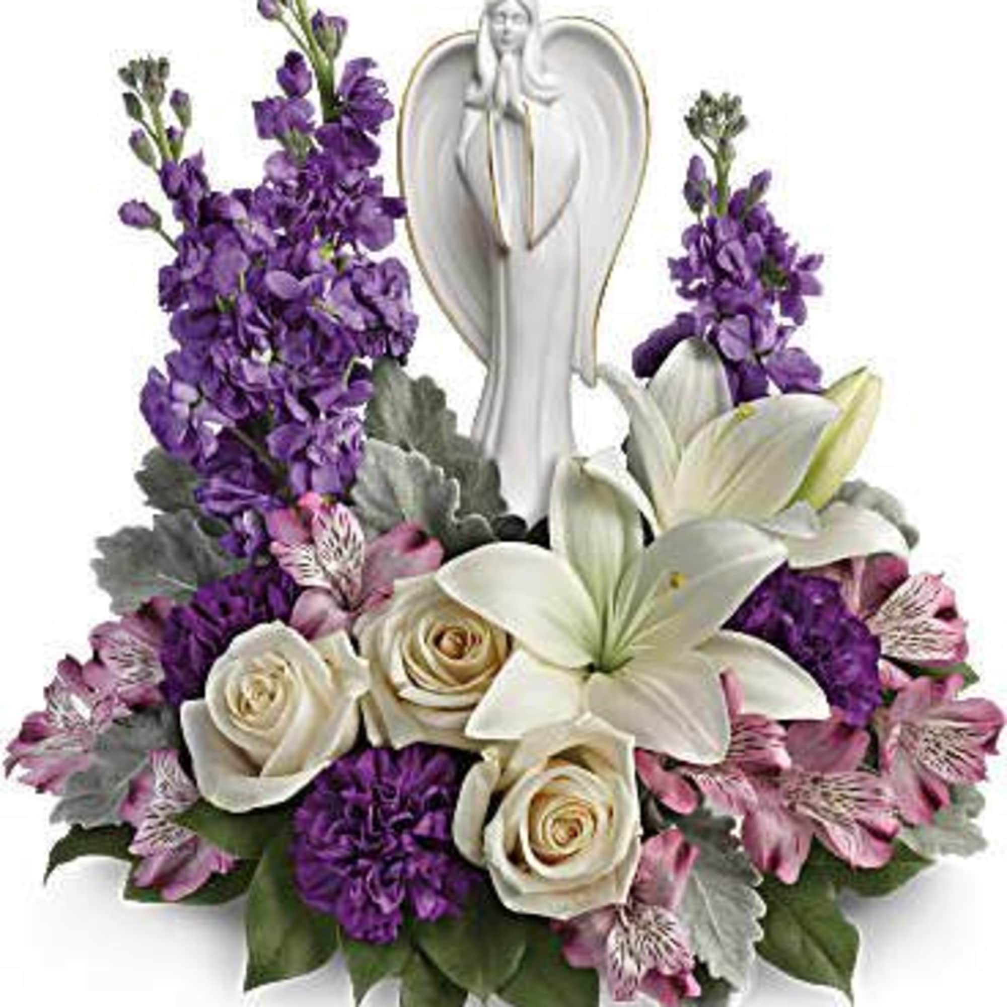 Purple and white floral arrangement with an angel figurine