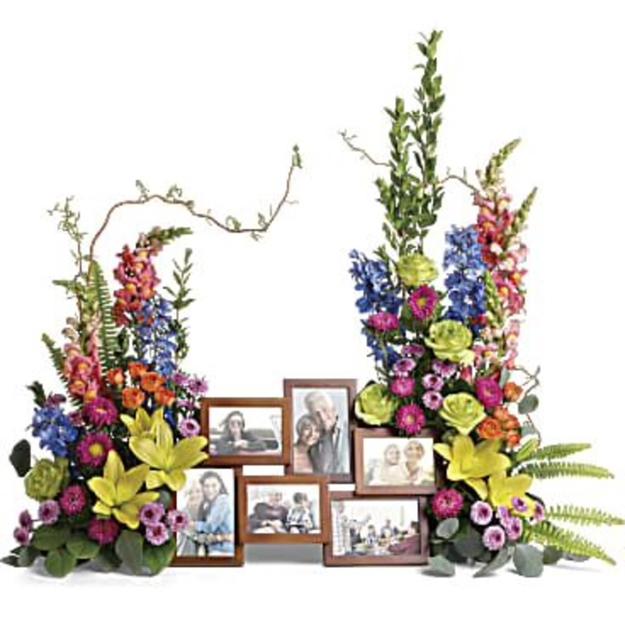 Floral photo display with colorful arrangements around framed pictures