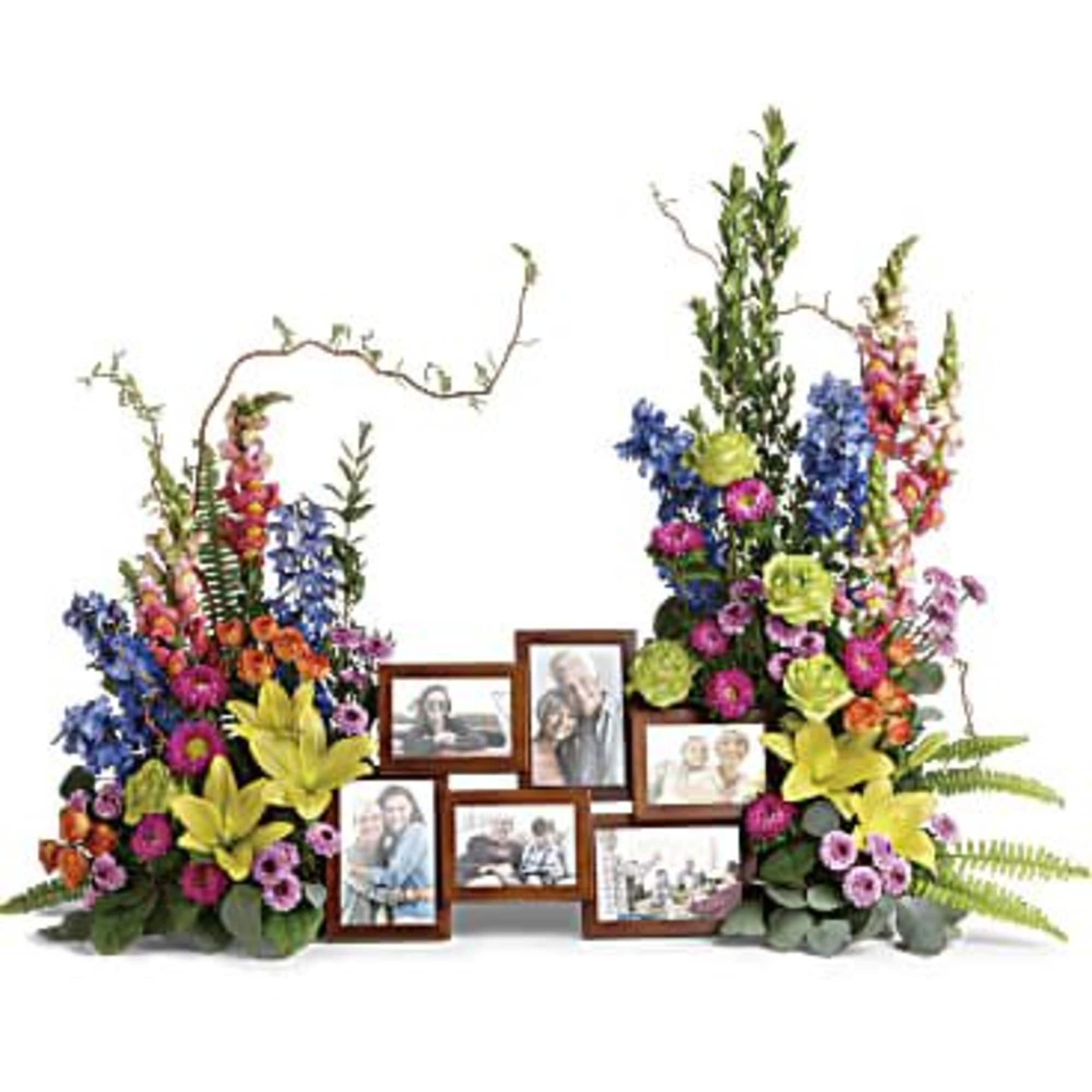Floral photo display with framed pictures and colorful flowers