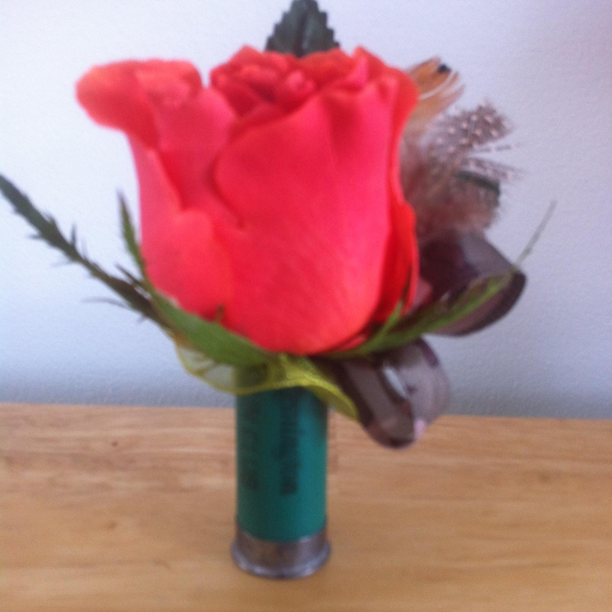 Single red rose in a small glass vase