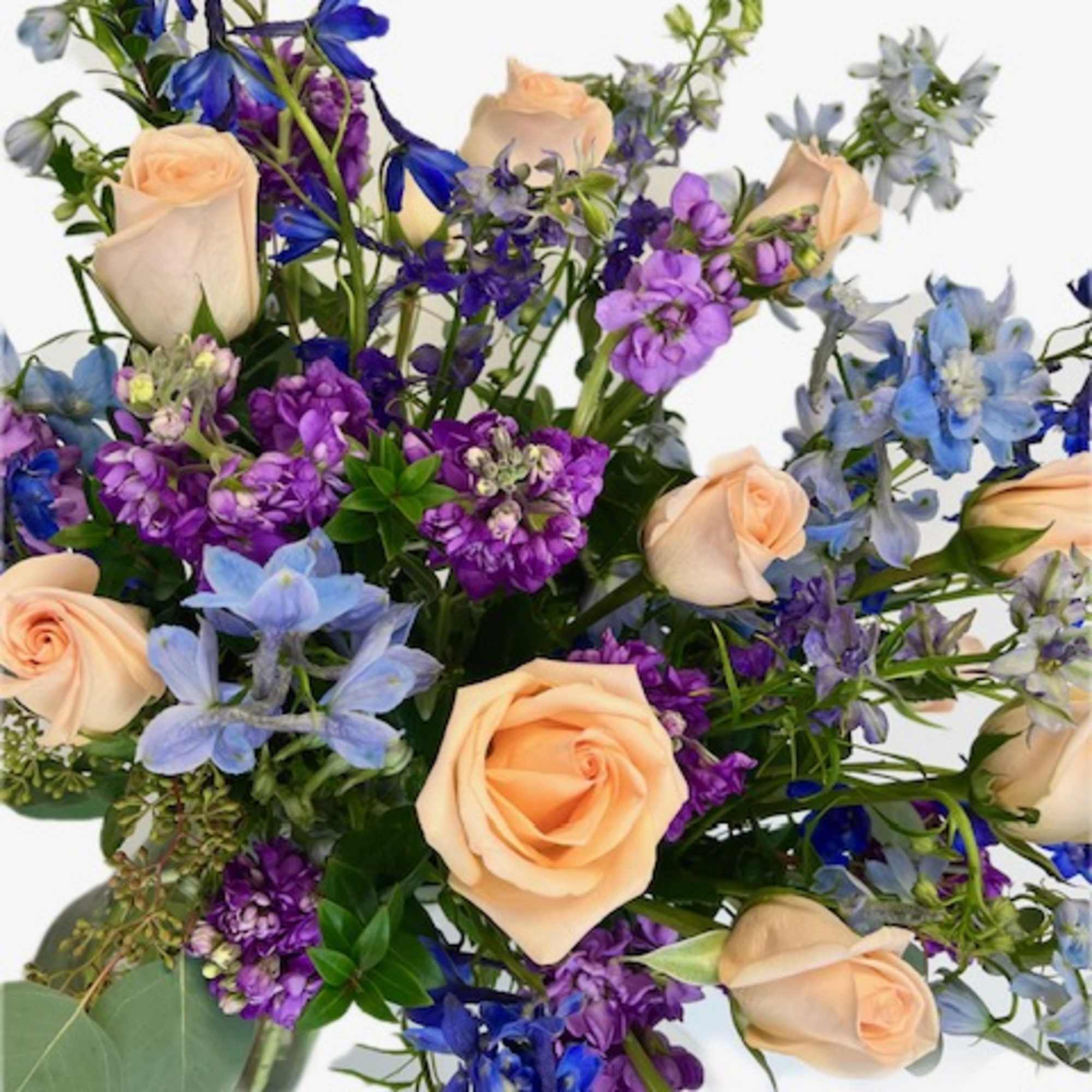 Bouquet of peach roses with blue and purple flowers