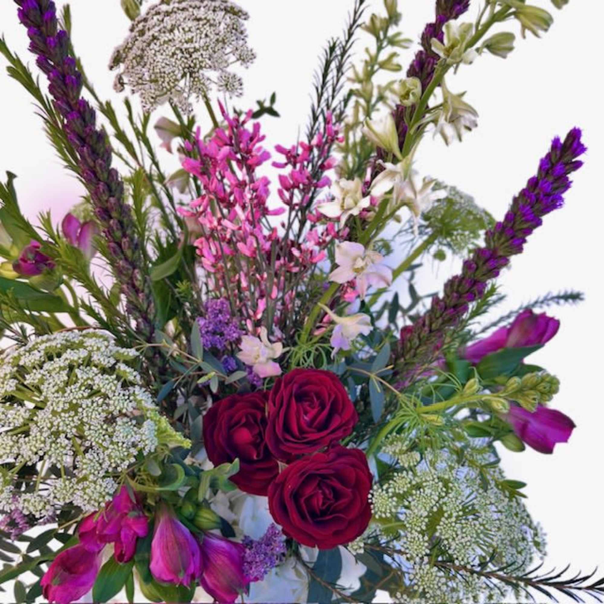 Bouquet with red roses, purple blooms, and white filler flowers