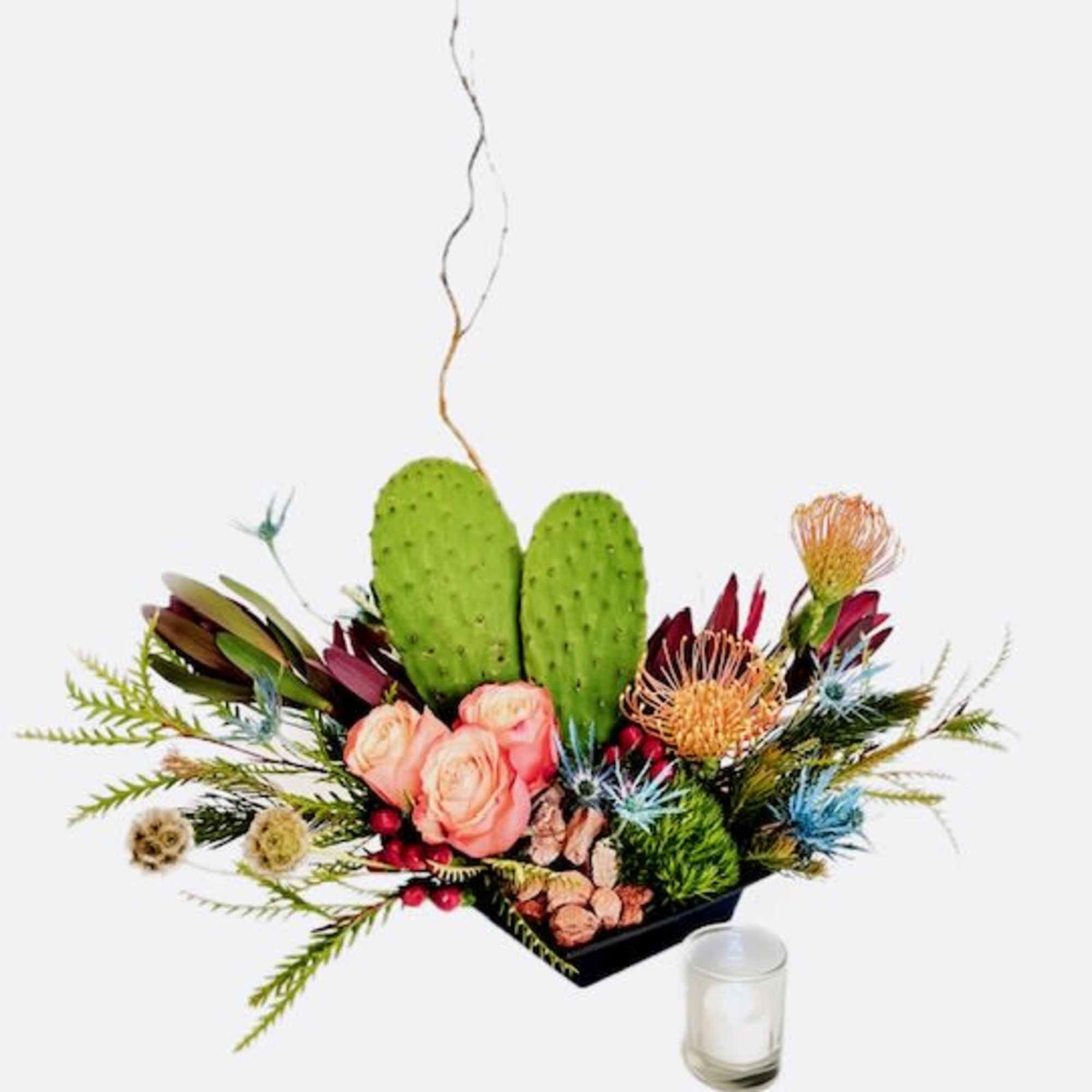 Floral arrangement with pink roses, protea, and cactus pads in a black container