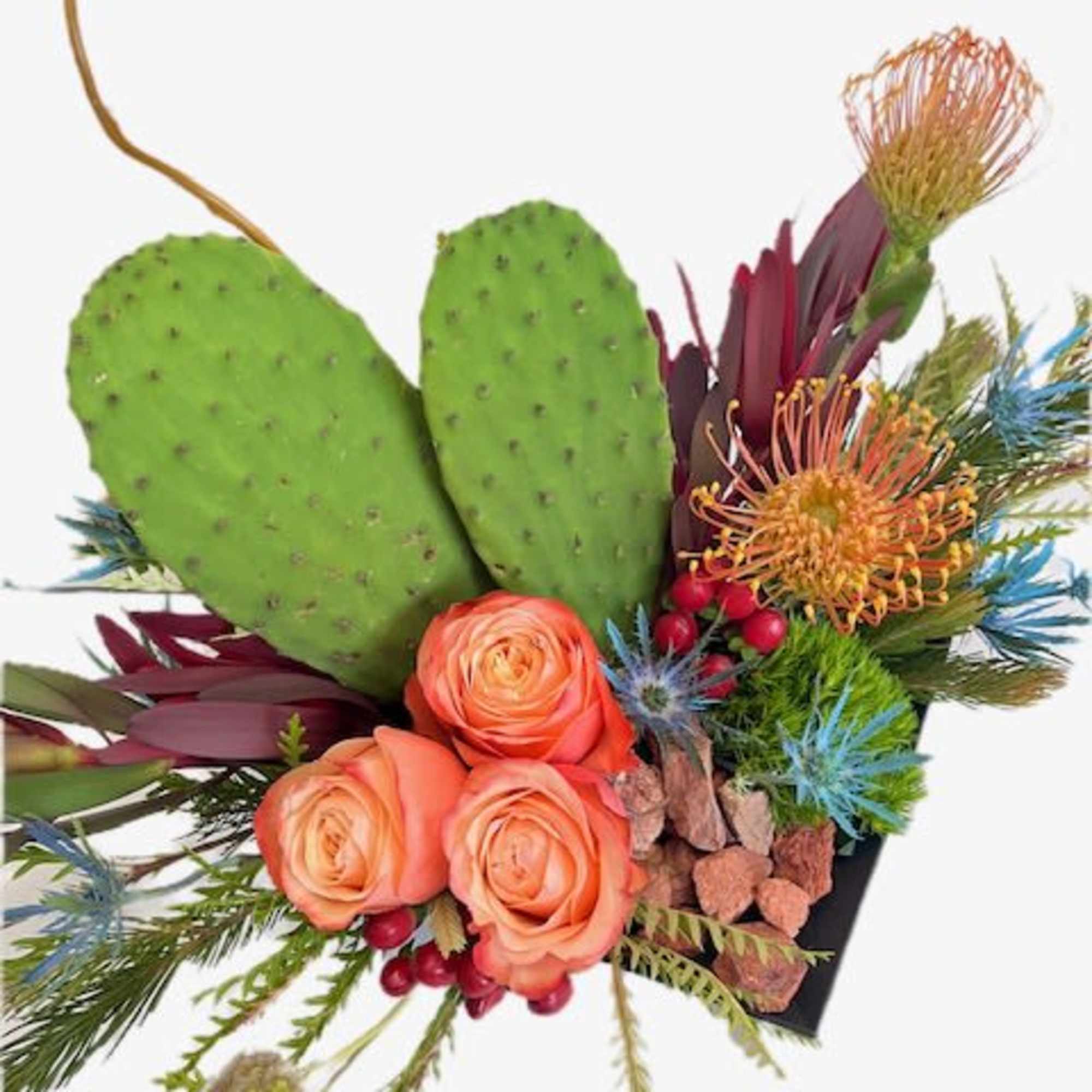 Arrangement with orange roses and cactus pads in a black container