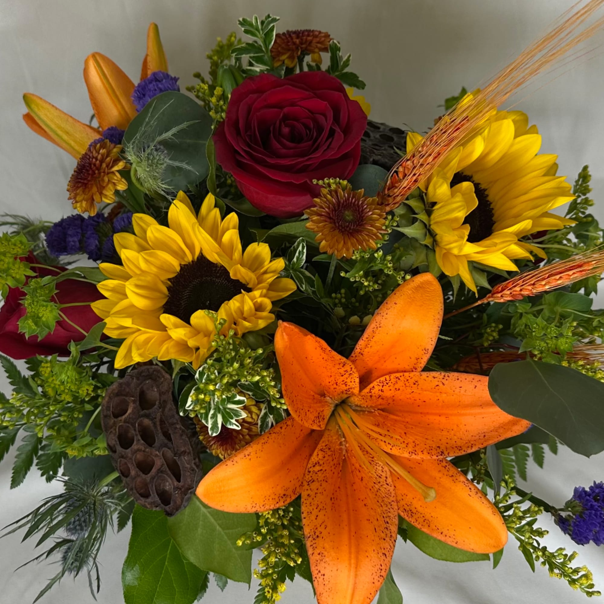 Mixed bouquet with a red rose, sunflowers, and an orange lily