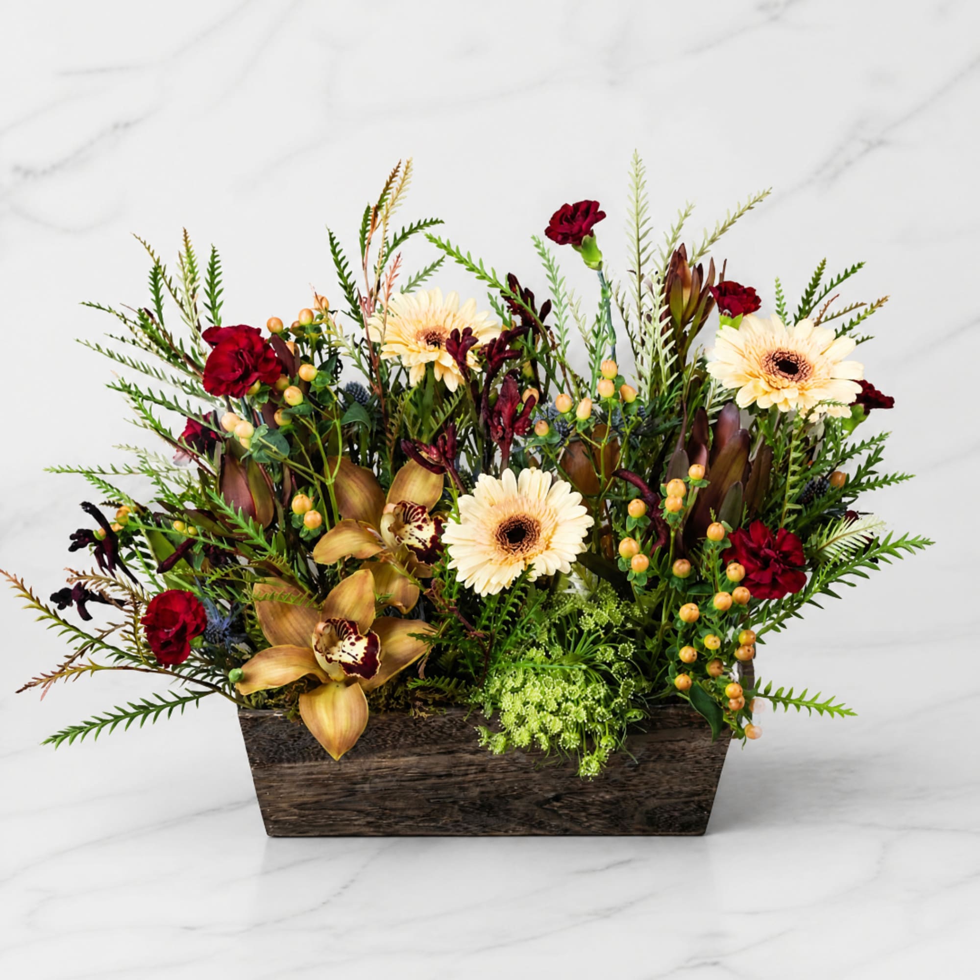 Mixed floral arrangement in a wooden rectangular container