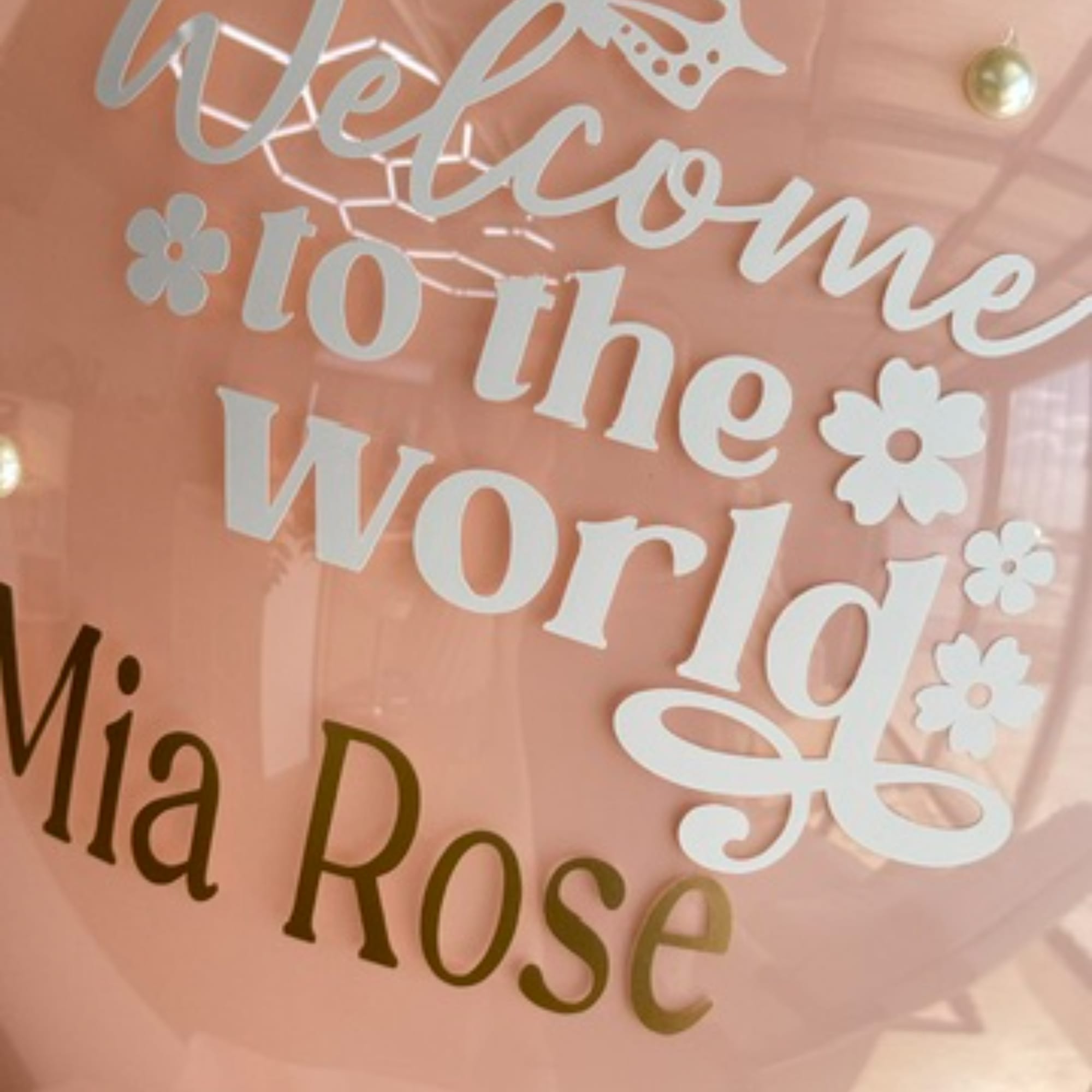 Pink balloon with white "Welcome to the World" text and "Mia Rose" name