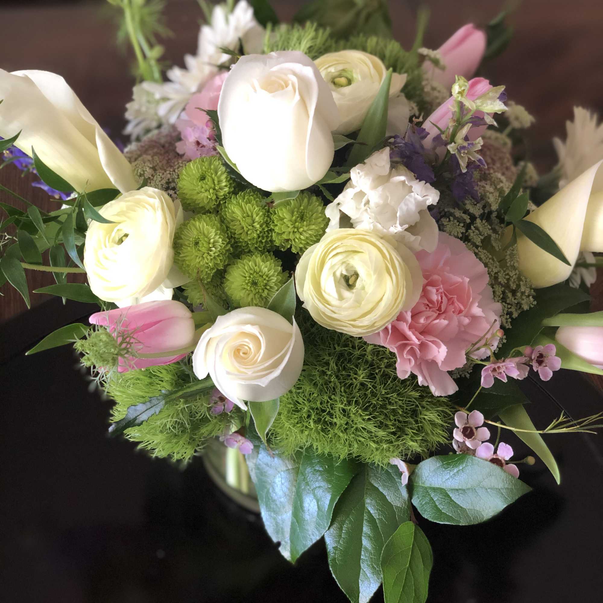 Bouquet of white and pink flowers with green accents
