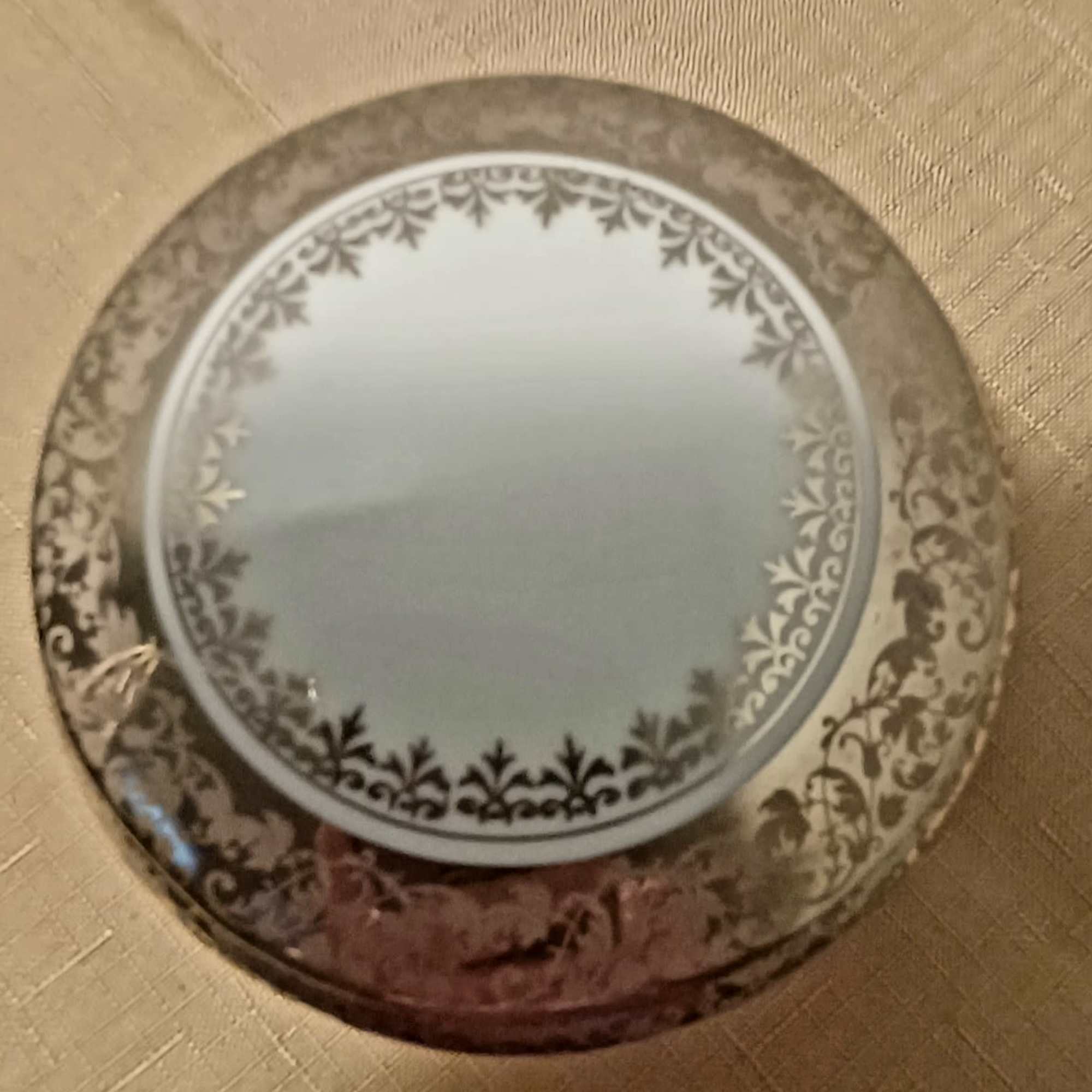Round decorative mirror with ornate floral border