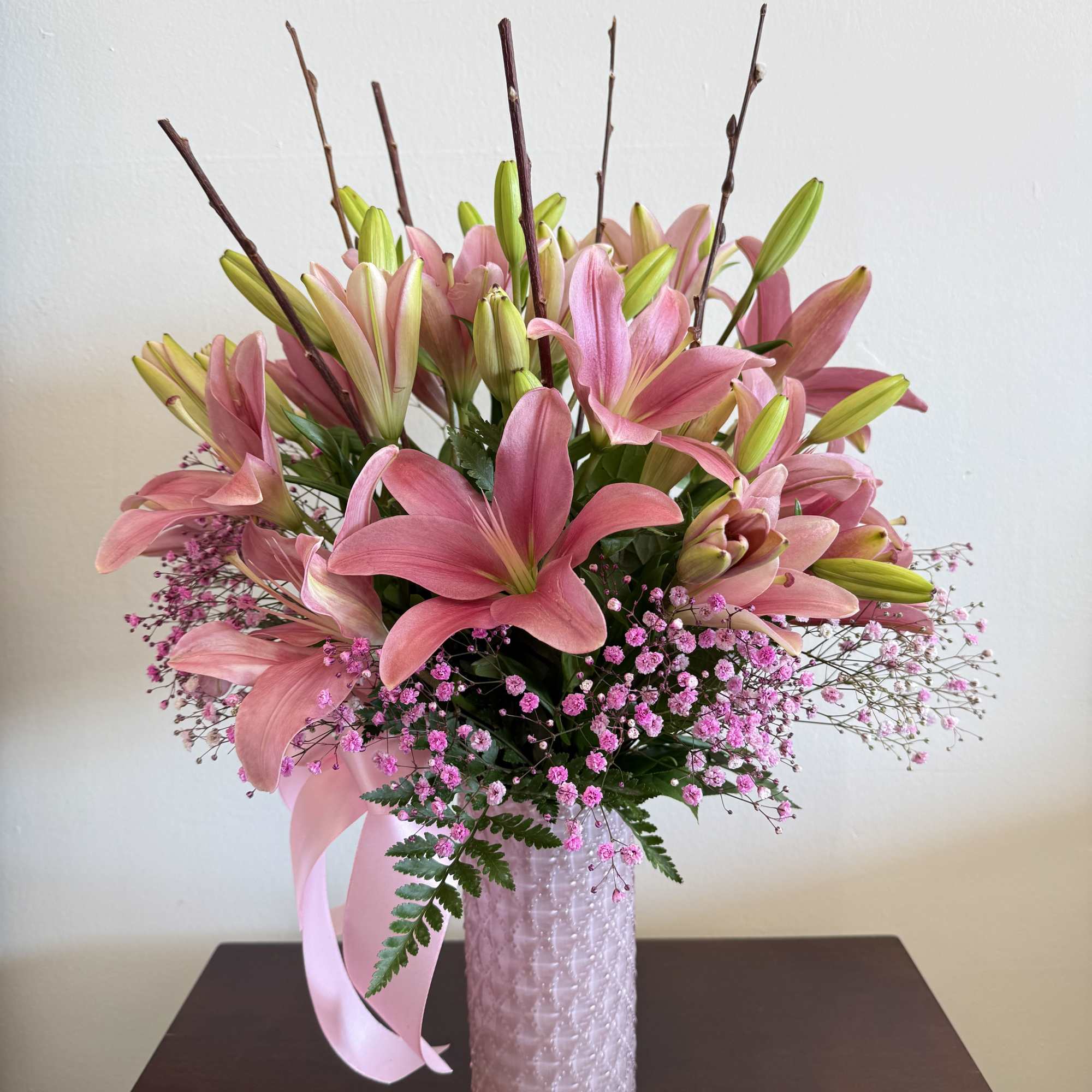 This stunning lily bouquet in a fancy pink vase