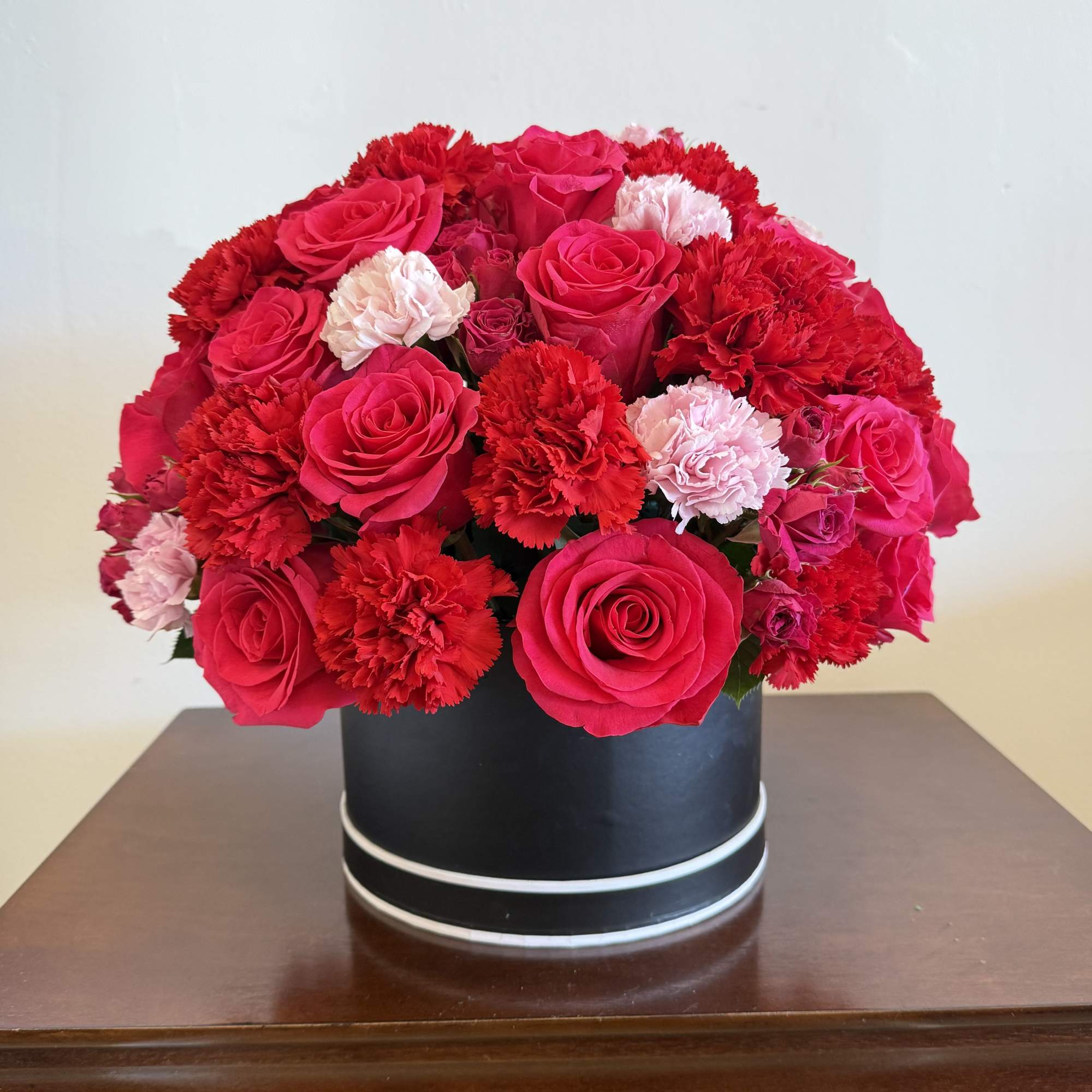 This arrangement is topped with 20-25 roses along the way of fine