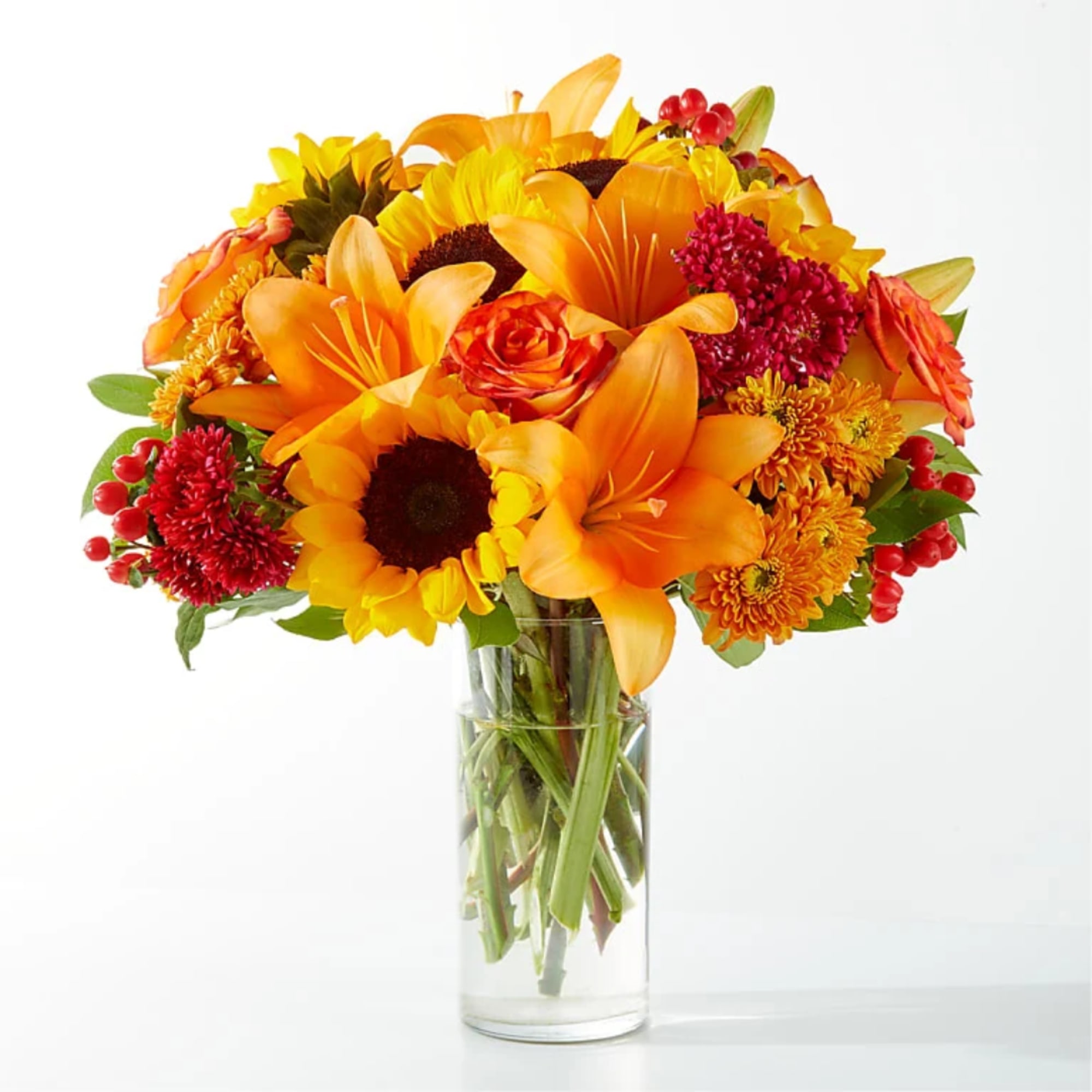 Orange and yellow mixed bouquet in a clear glass vase