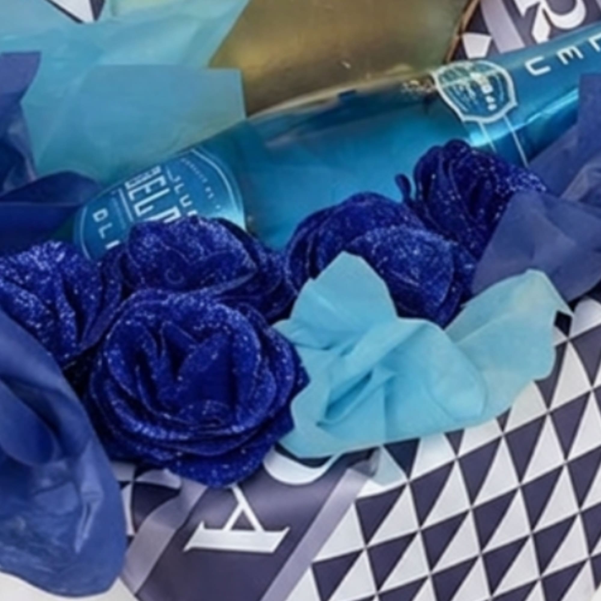 Blue roses with a light blue bow and wrapped bouquet packaging