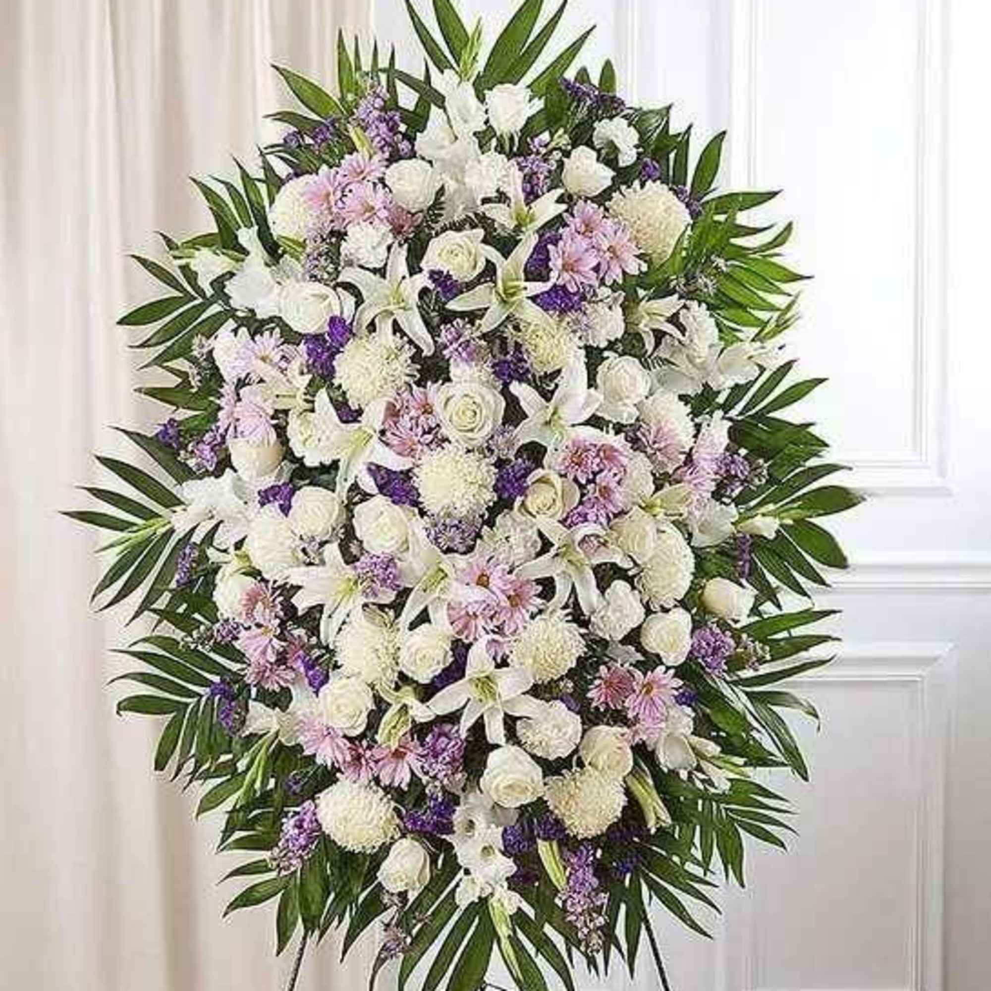 Large white and lavender funeral spray with palm leaves