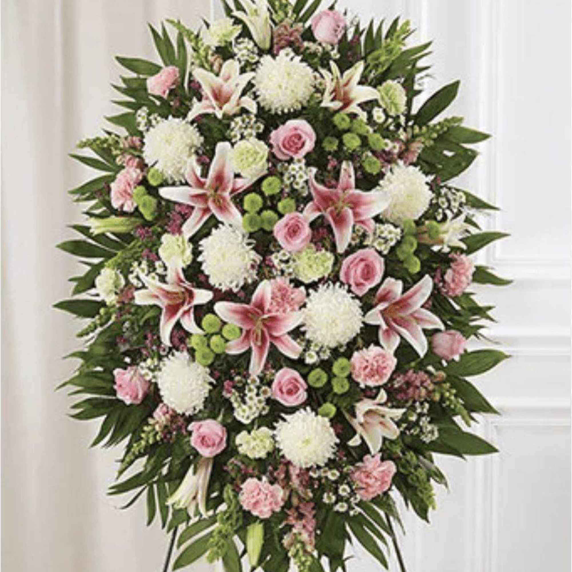 Standing spray of pink and white flowers on an easel