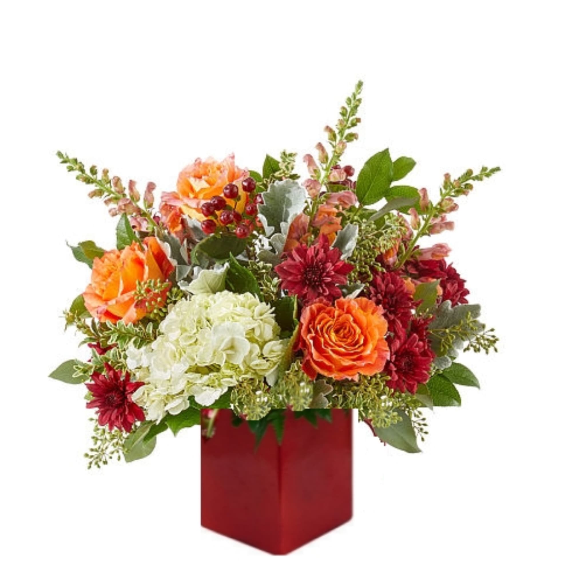 Mixed bouquet in a red square vase with orange, red, and white blooms