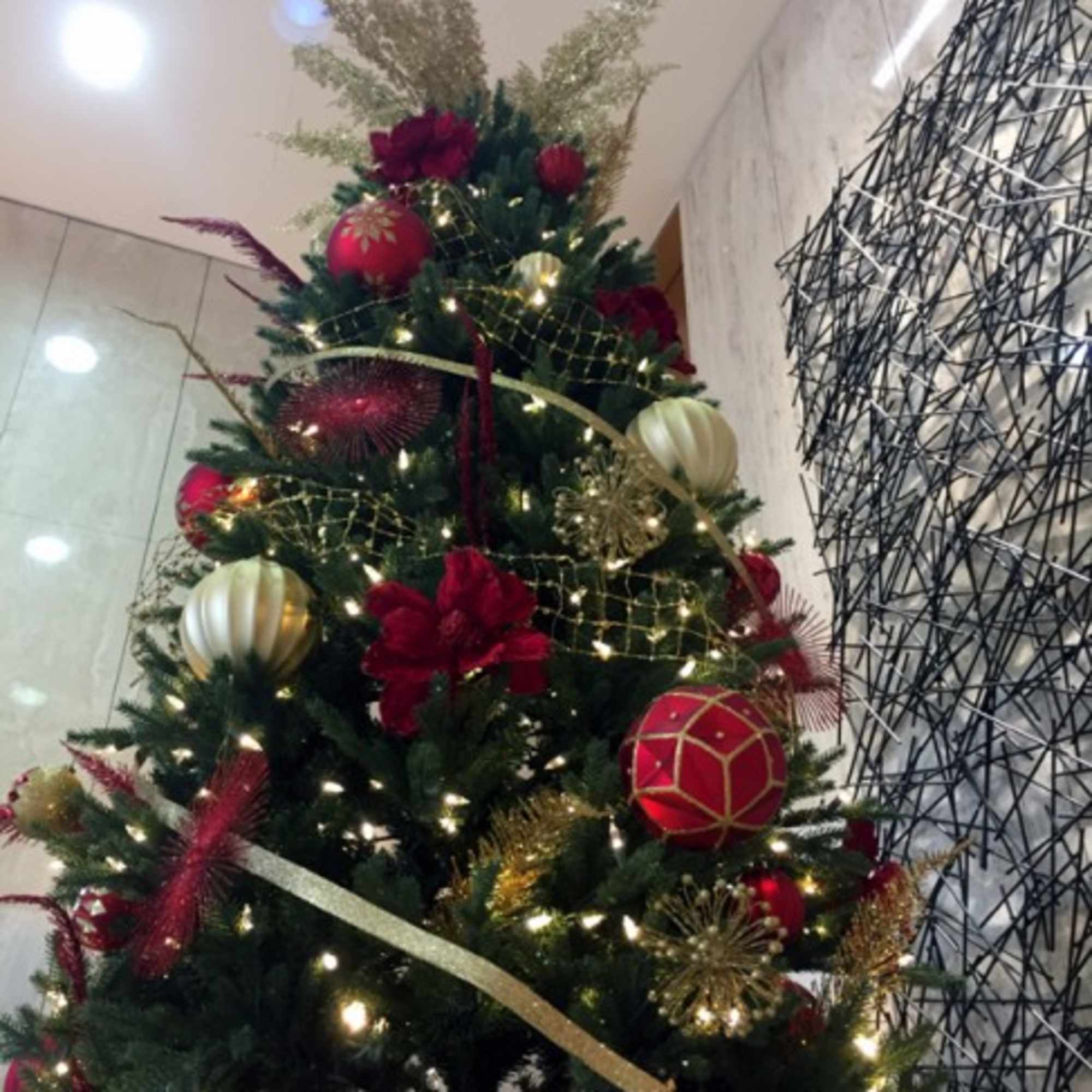 Decorated Christmas tree with red and gold ornaments and lights