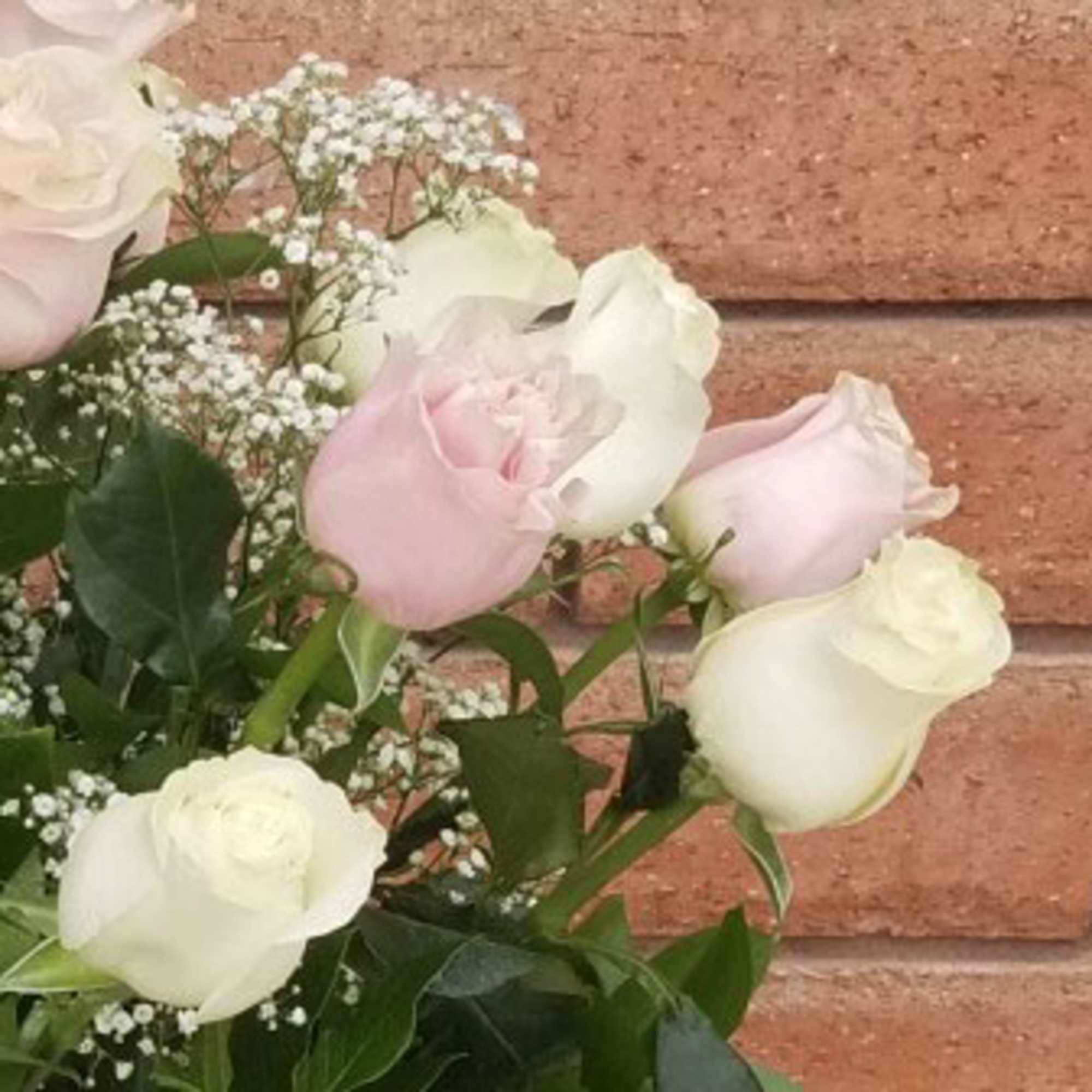 Bouquet of pale pink and white roses with baby's breath