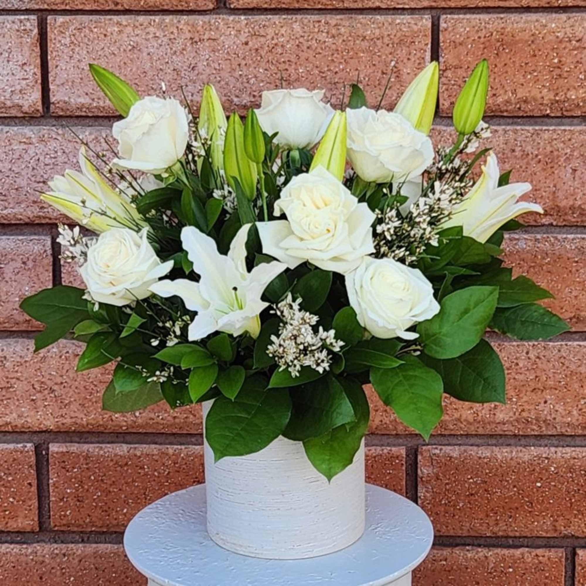 White roses and lilies arranged in a white vase, photo 2 of 4