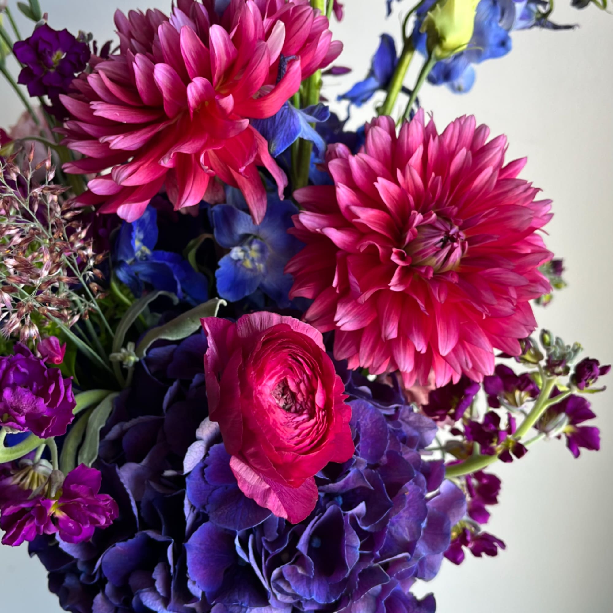 Bouquet of pink dahlias, purple hydrangeas, and blue flowers