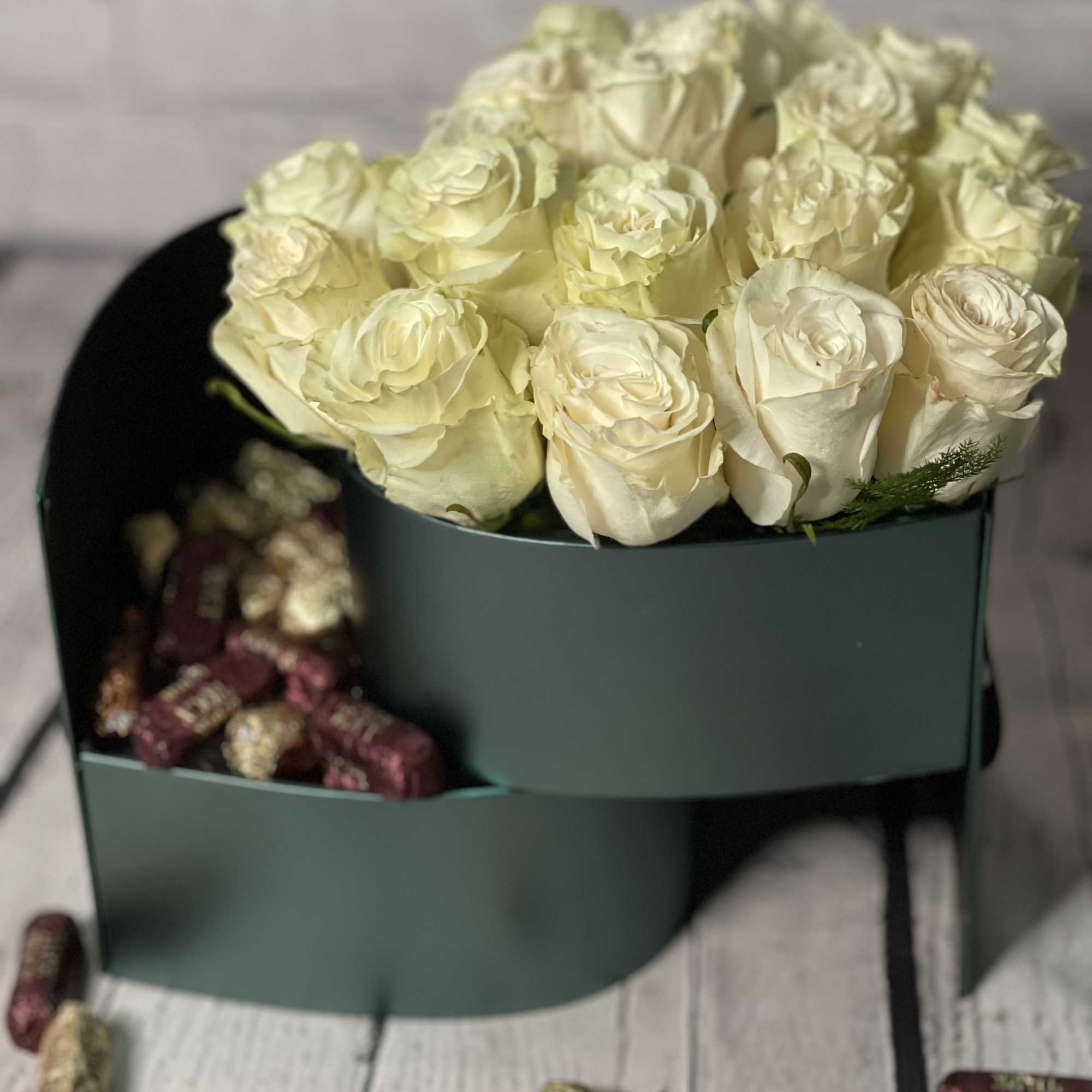 Cream rose bouquet in a dark green box with chocolates