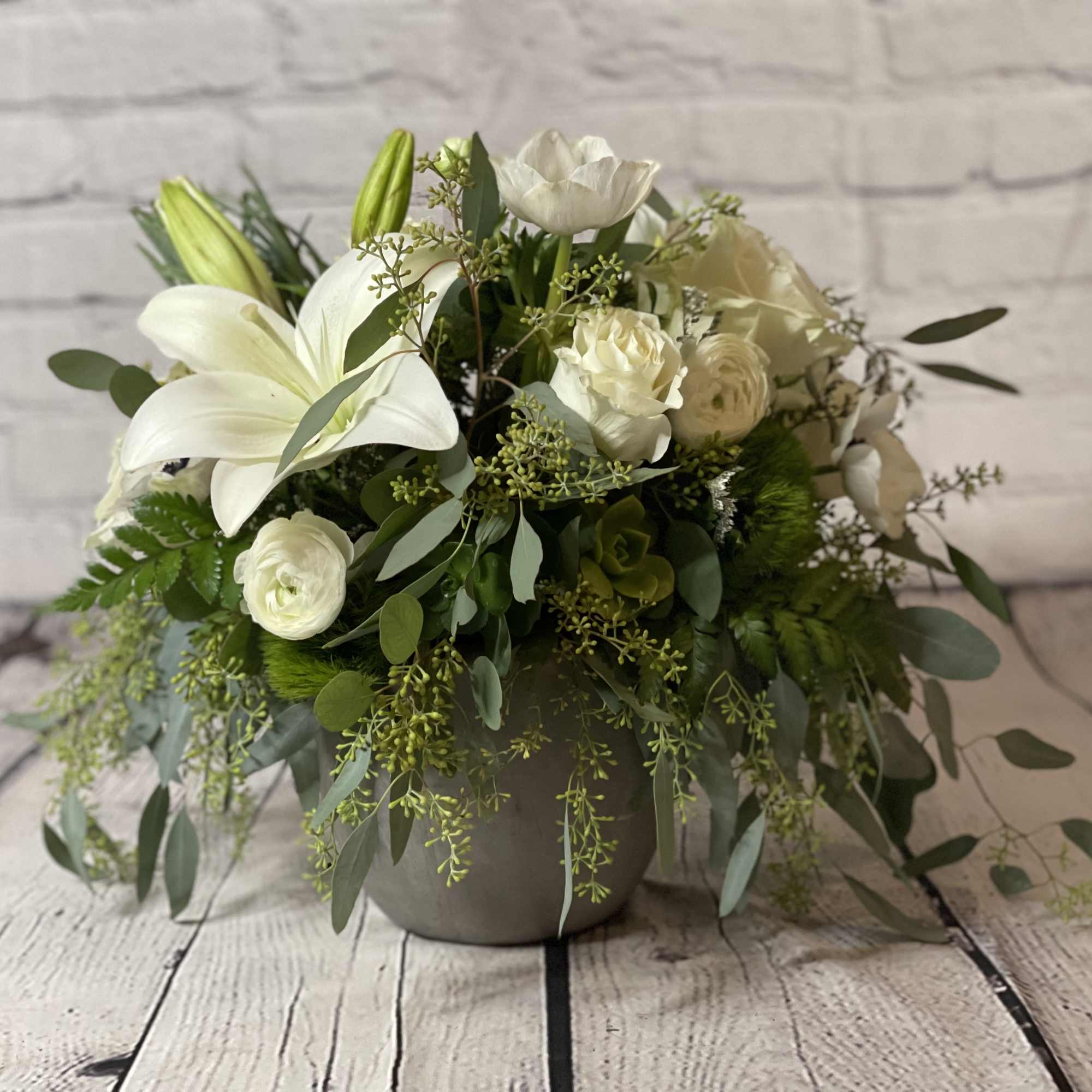 White lily and rose arrangement in a gray vase