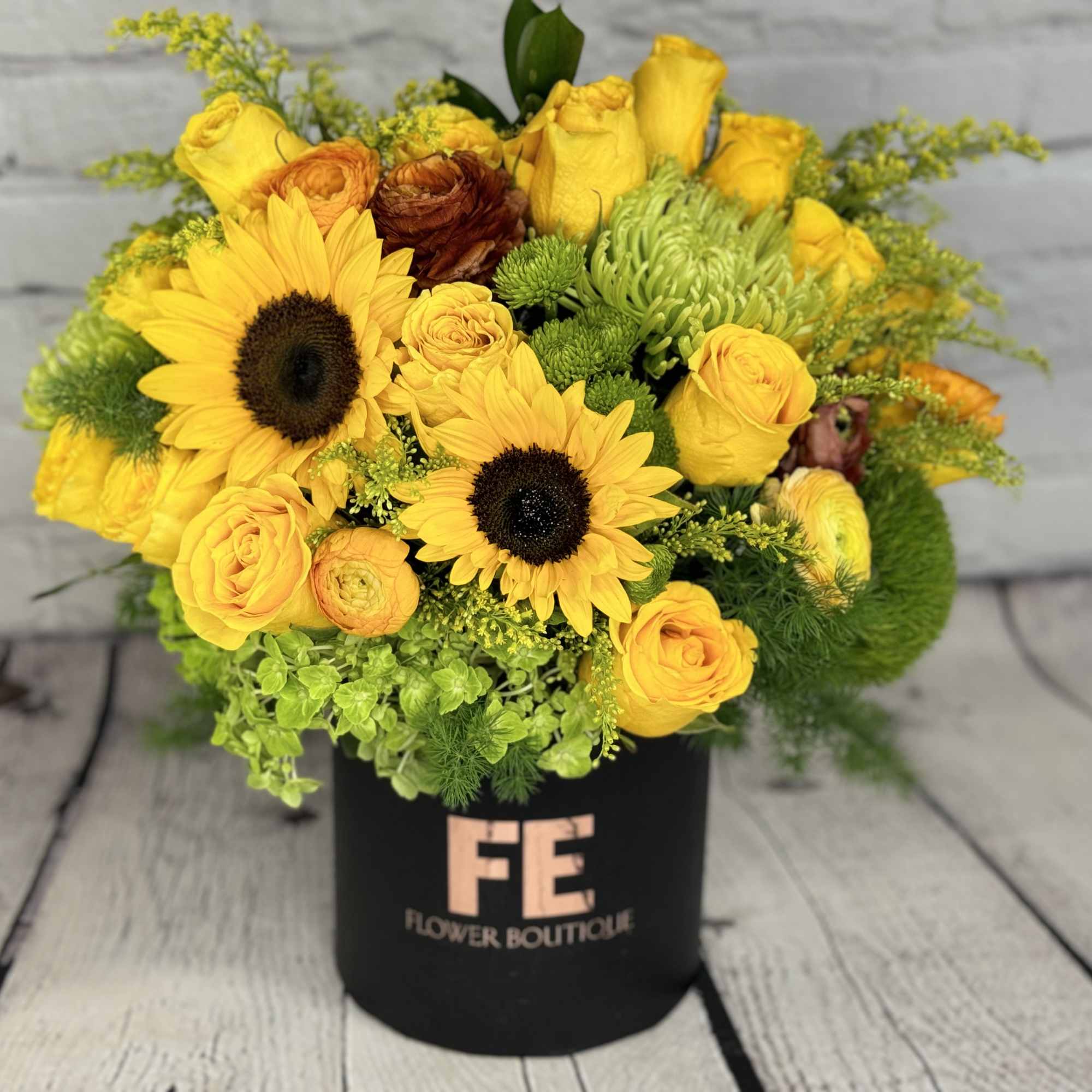 Yellow sunflower and rose bouquet in a black box