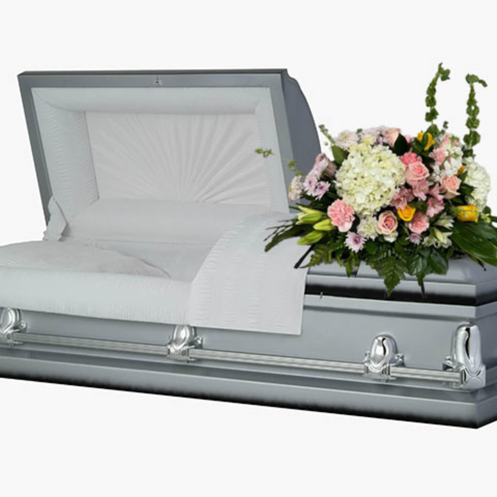 White casket with a pastel floral spray on top