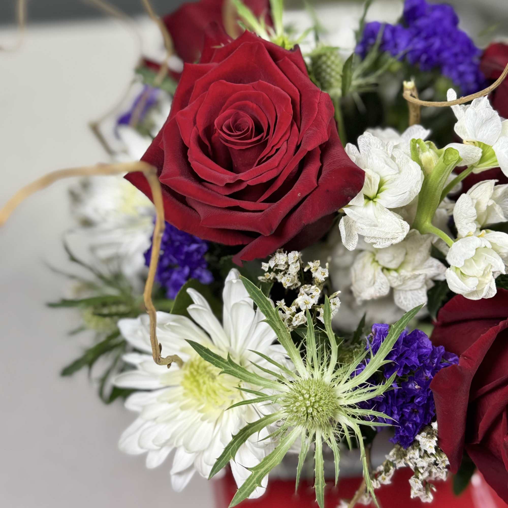 Bouquet of red roses with white and purple flowers