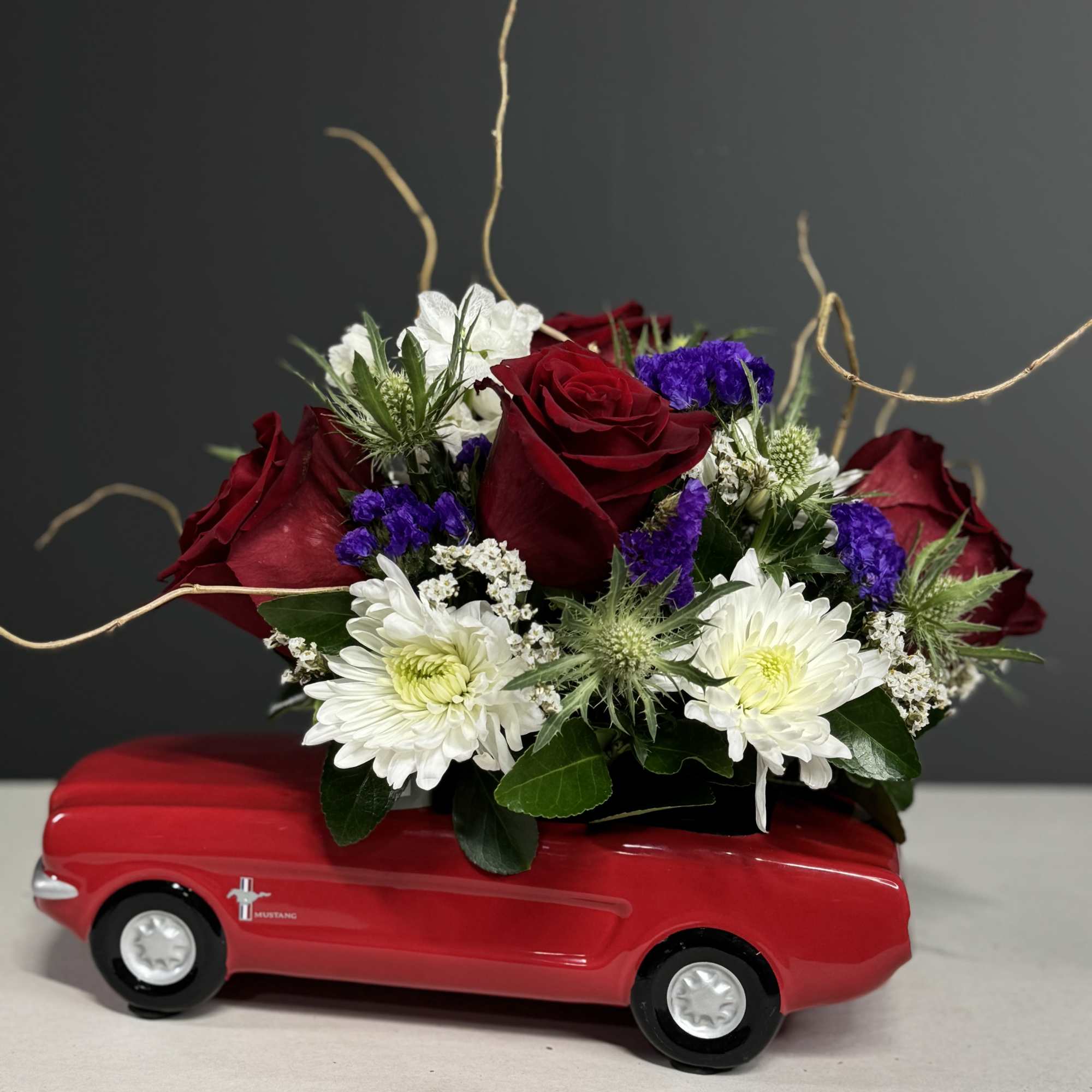 Red roses and white daisies arranged in a red toy car, photo 4 of 4