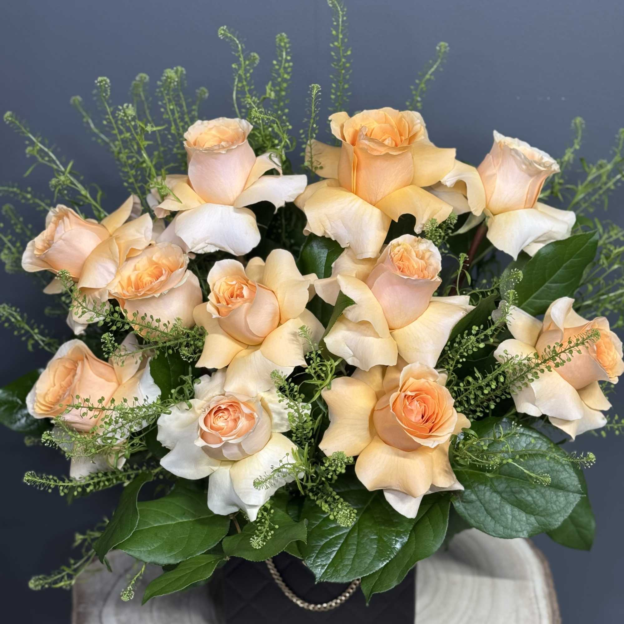 Peach roses arranged in a black box with greenery, photo 3 of 3