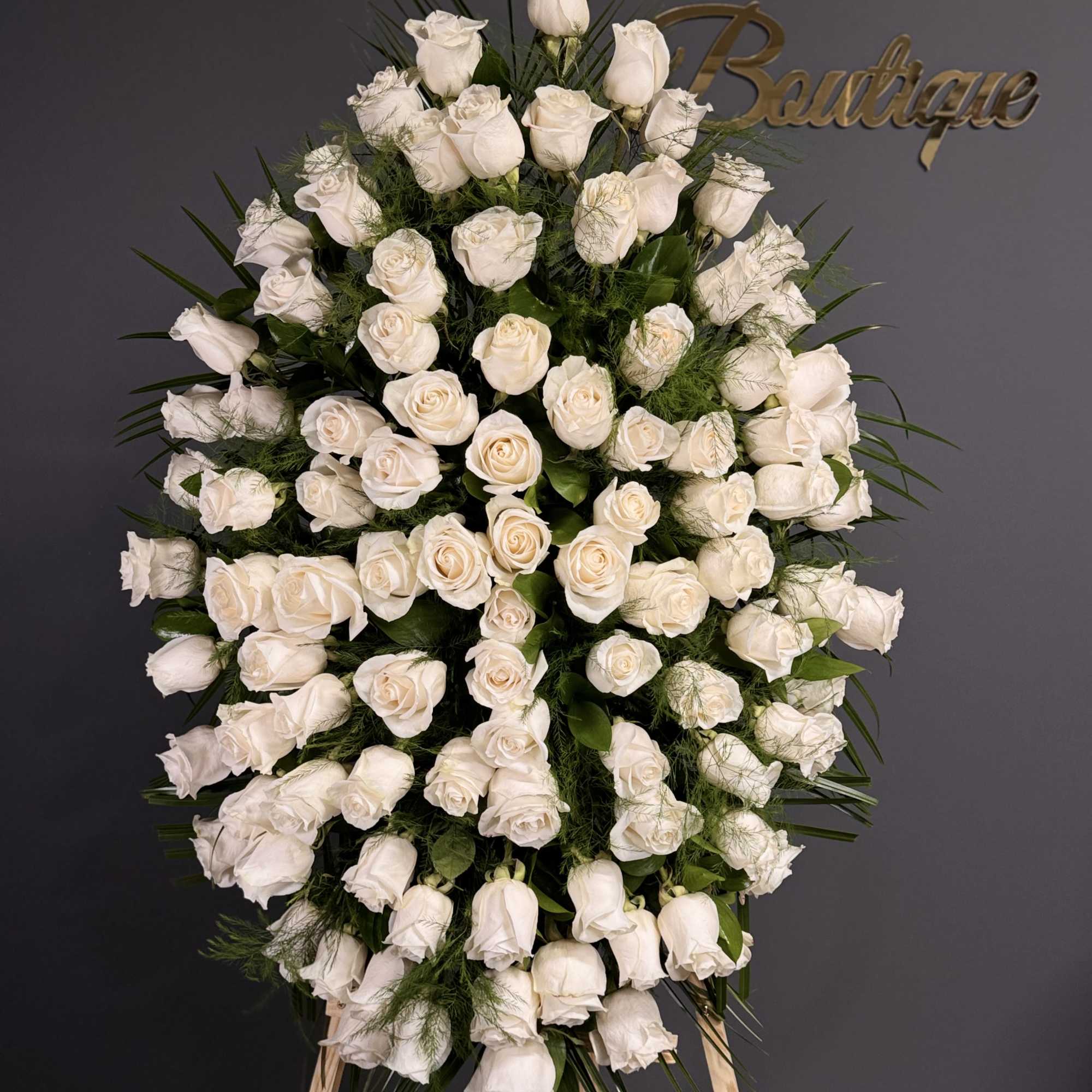 Large standing spray of white roses on an easel