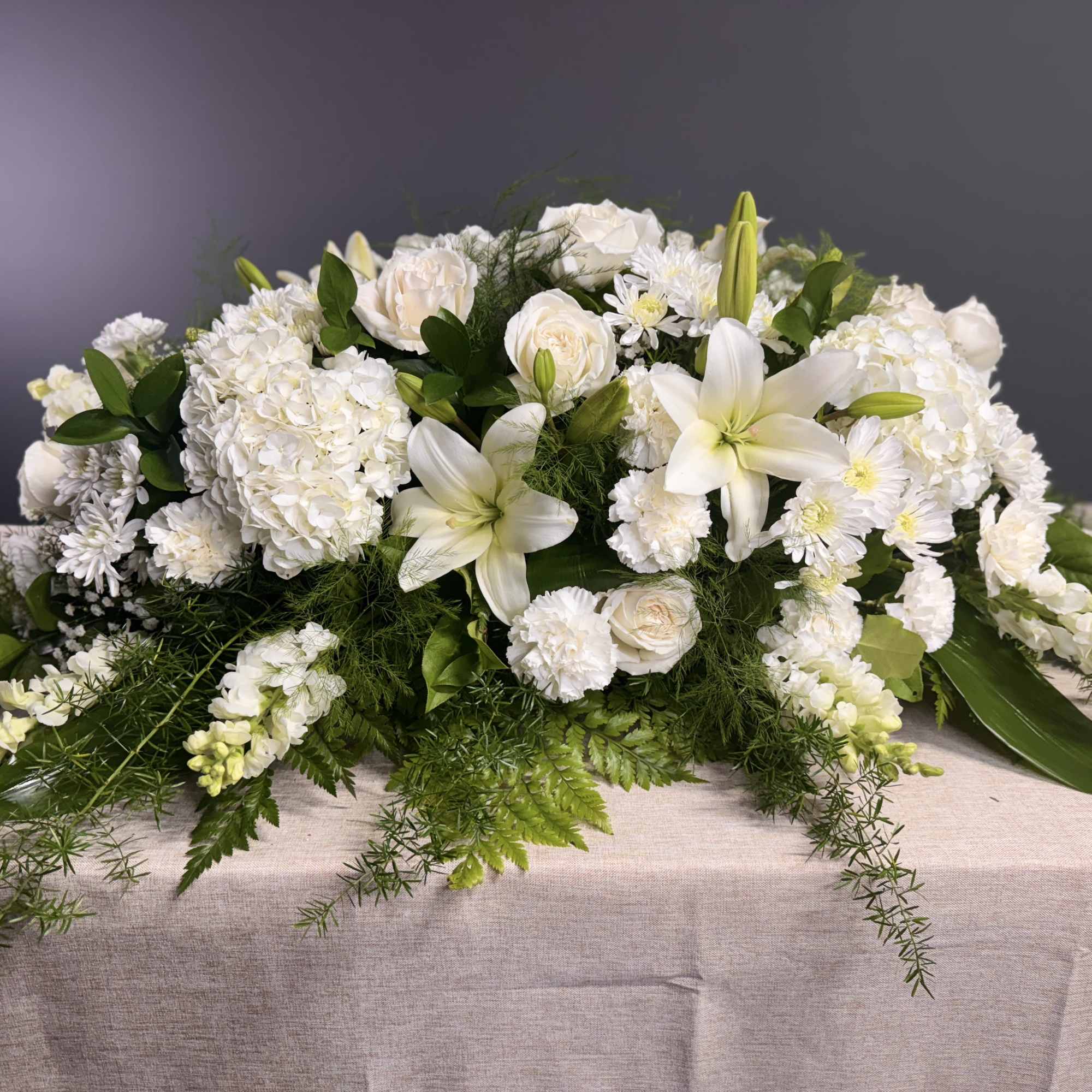 White floral casket spray with lilies, roses, and hydrangeas, photo 3 of 4