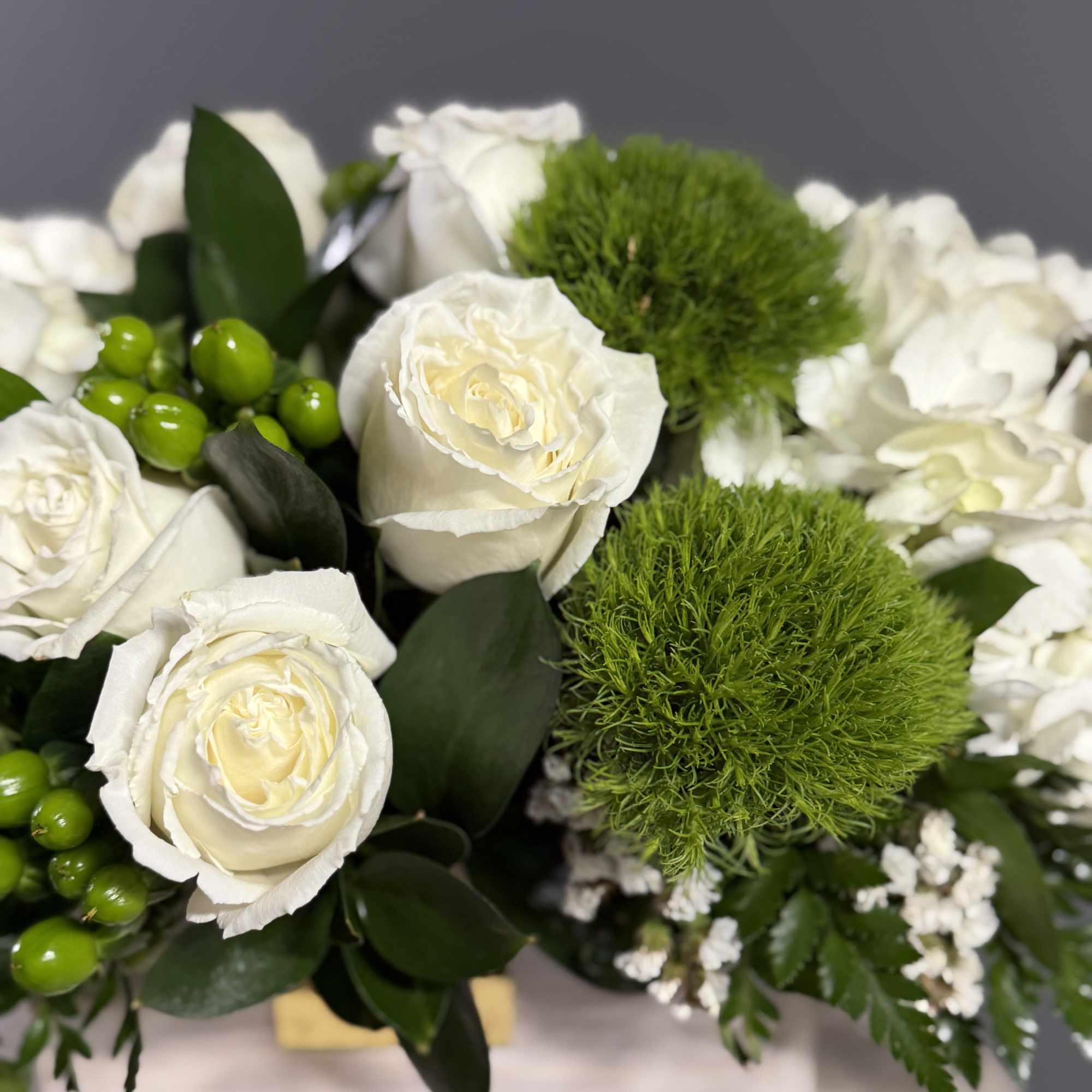 This crisp white and green arrangement includes roses, dianthus, and hydrangeas. The, photo 3 of 4