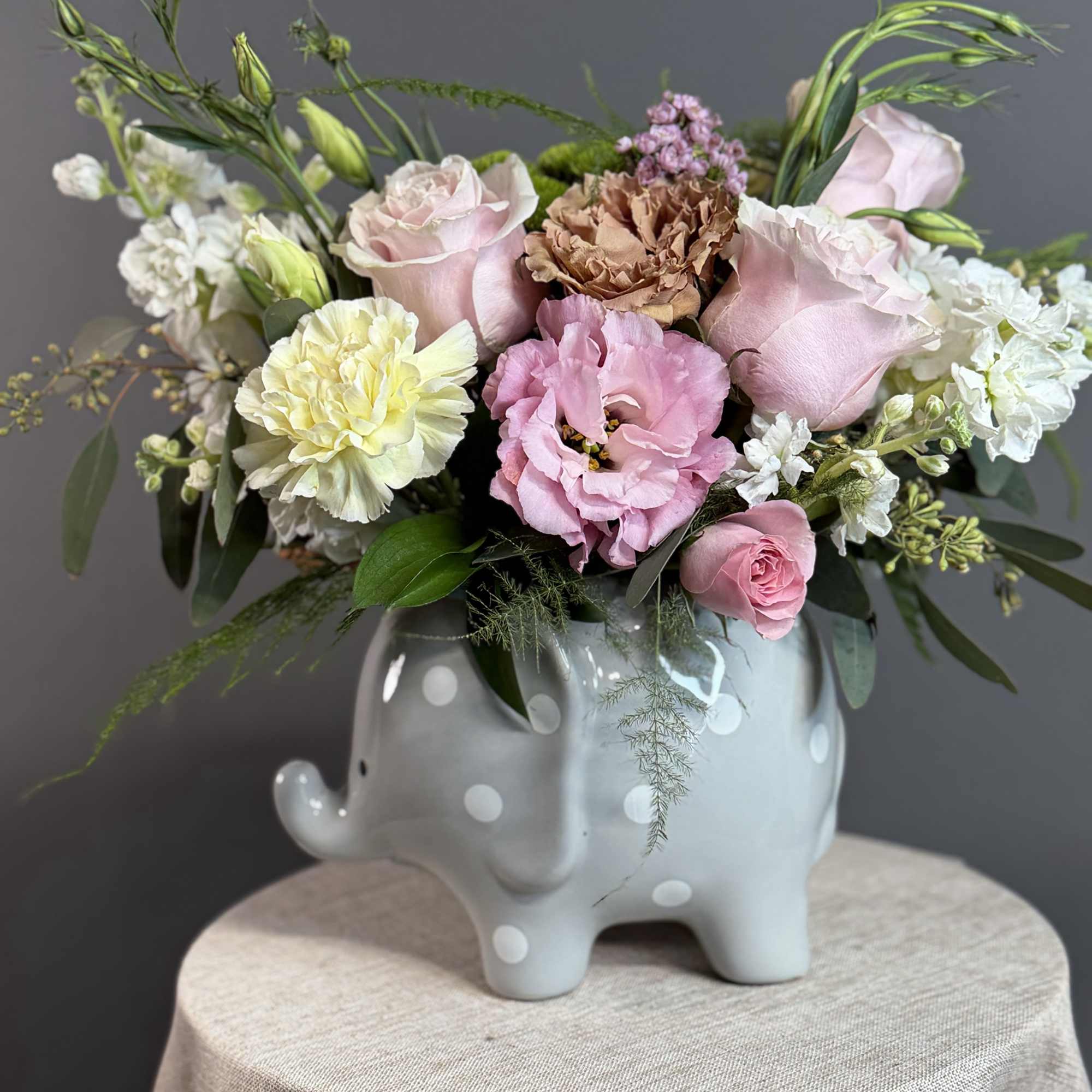 A sweet and delicate arrangement featuring soft pink blooms, creamy accents, and, photo 3 of 3