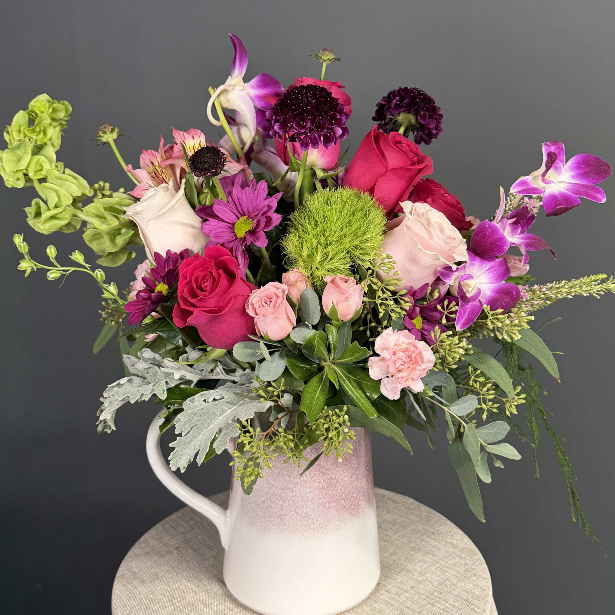 Capturing the untamed beauty of a wild meadow, this vibrant arrangement is