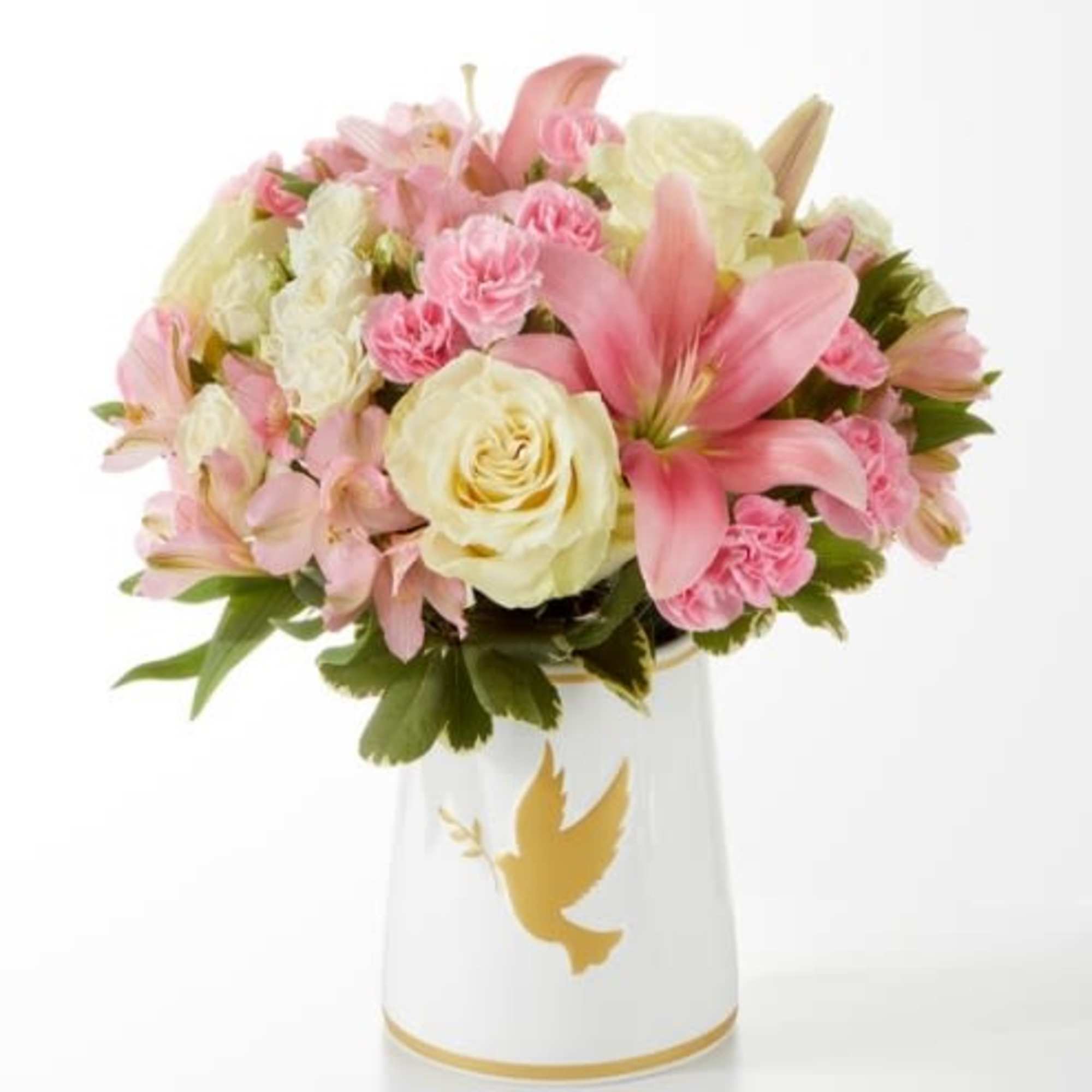 Pink and cream bouquet in a white vase with a gold dove design
