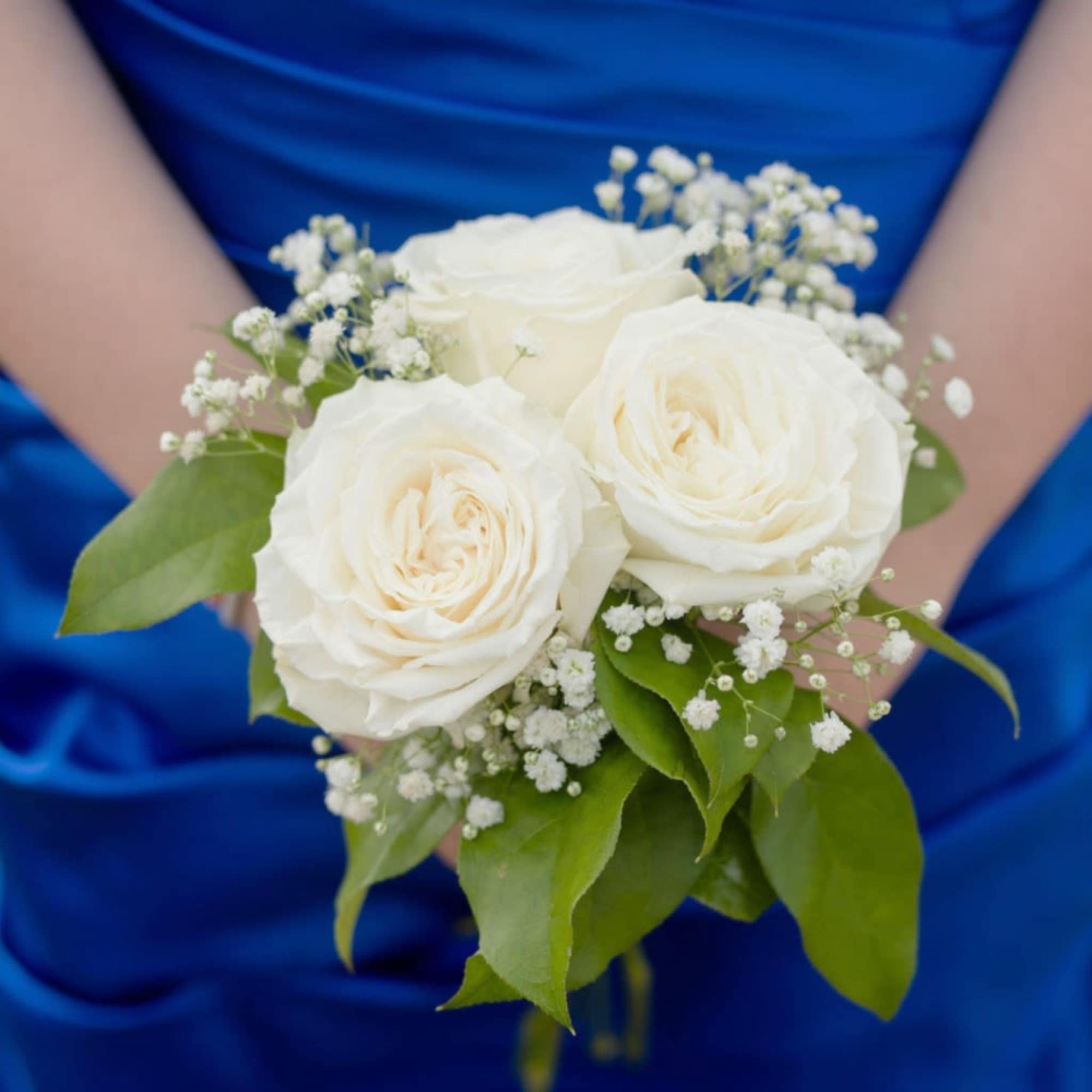 Three roses gathered in a hand-tied nosegay create a compact, elegant prom