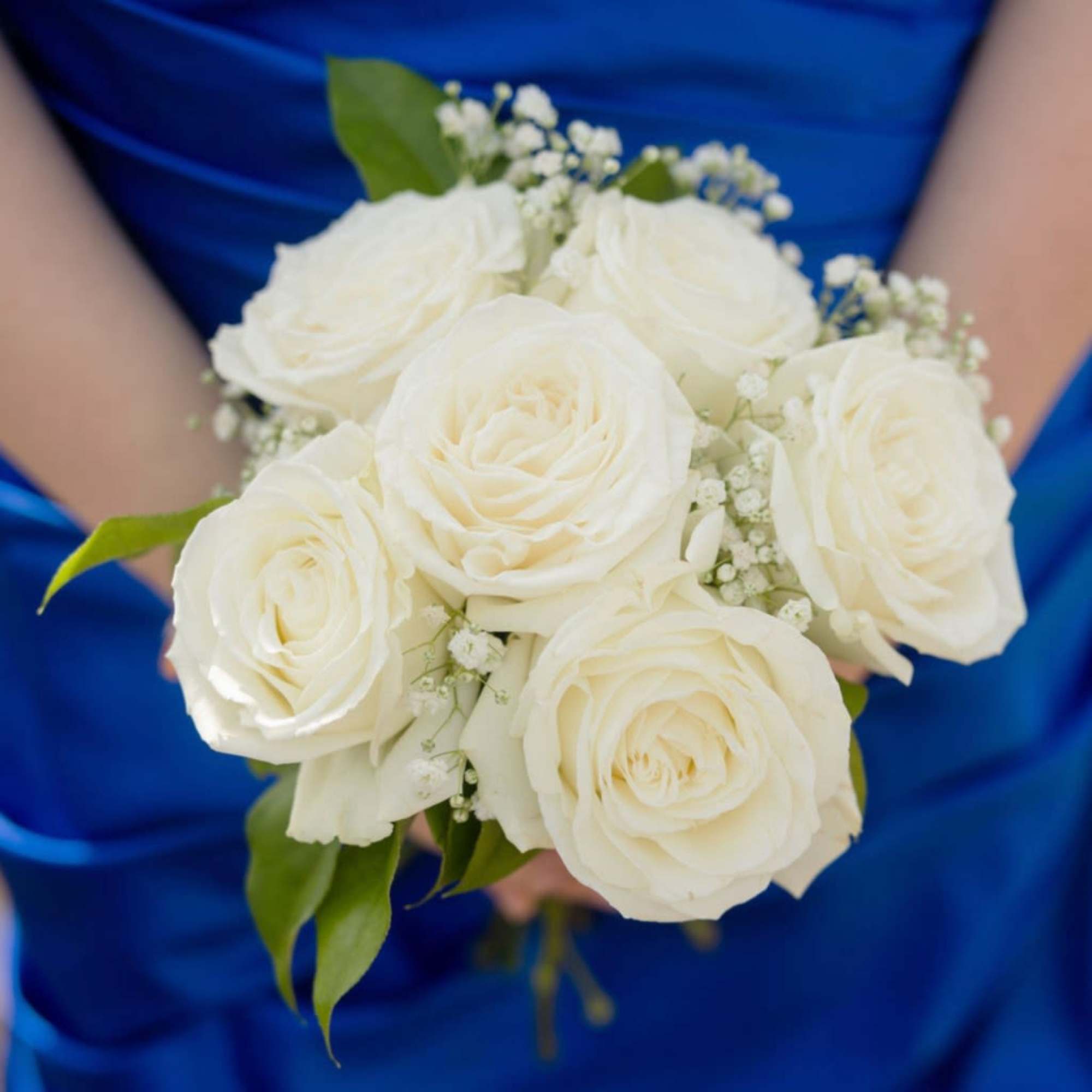 Three roses gathered in a hand-tied nosegay create a compact, elegant prom