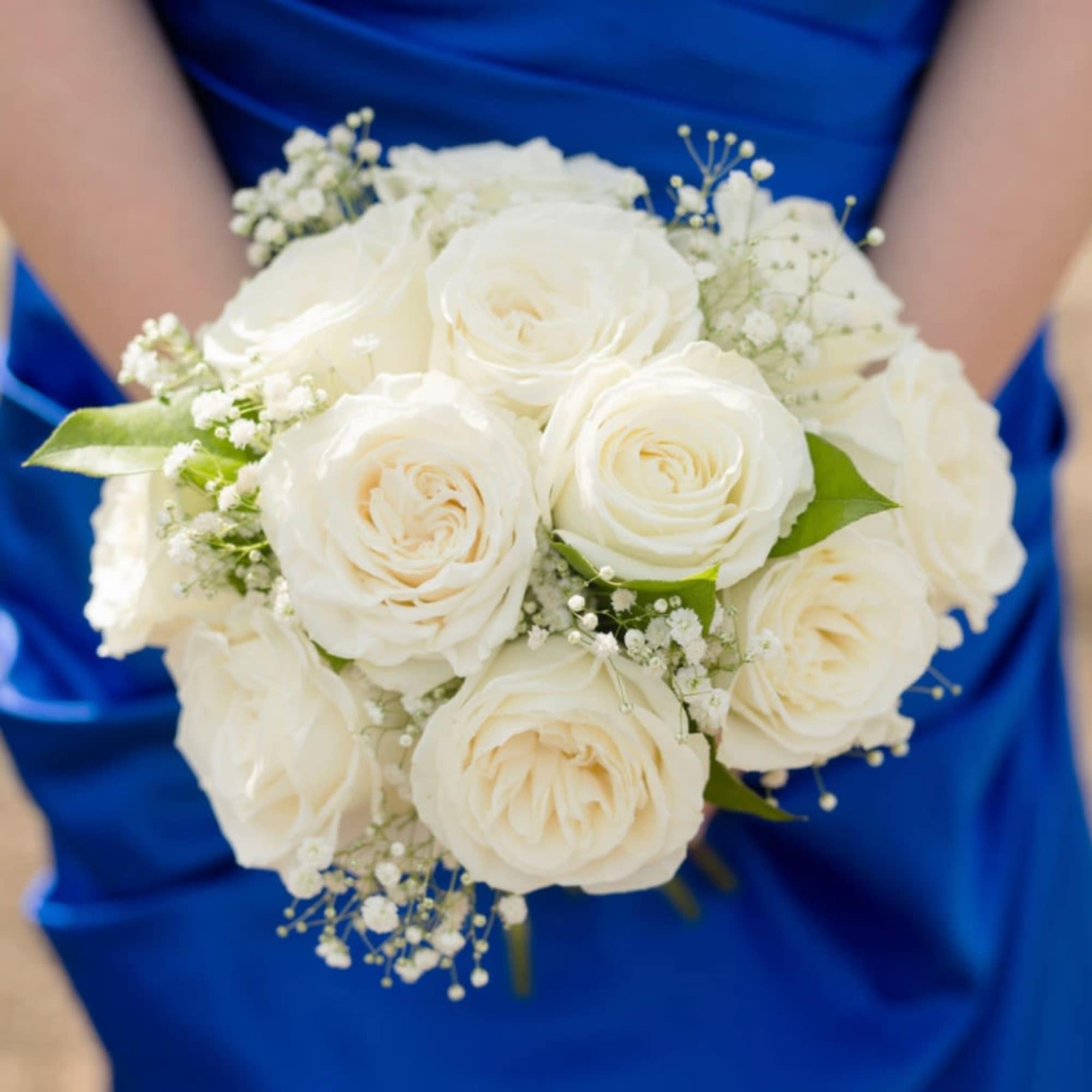 Three roses gathered in a hand-tied nosegay create a compact, elegant prom