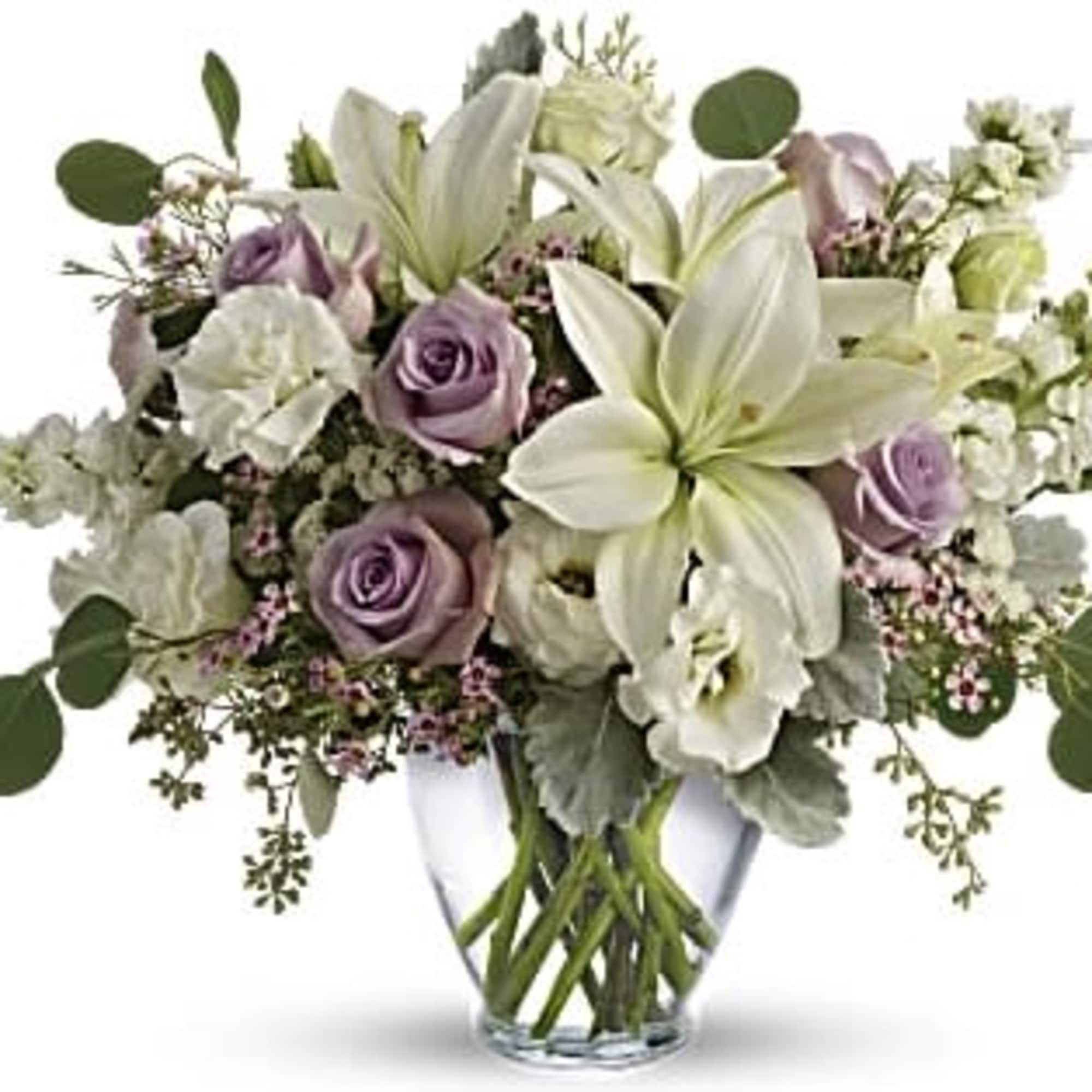 Lavender roses and white lilies in a clear glass vase