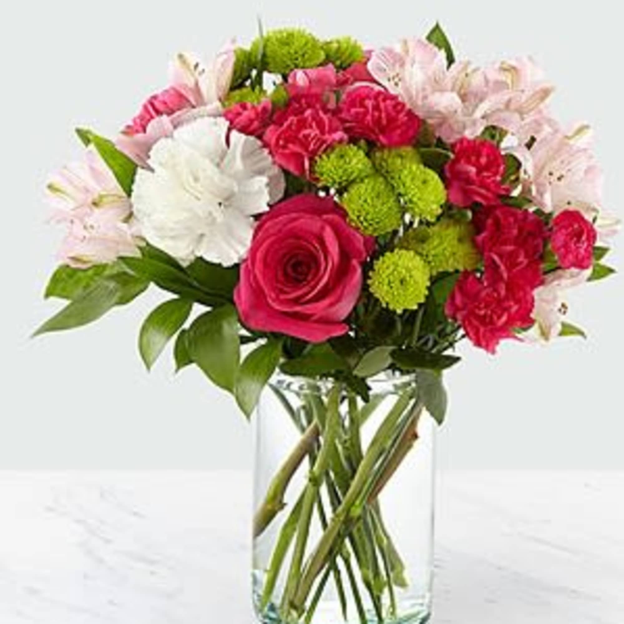 Bouquet of pink and white flowers in a clear glass vase