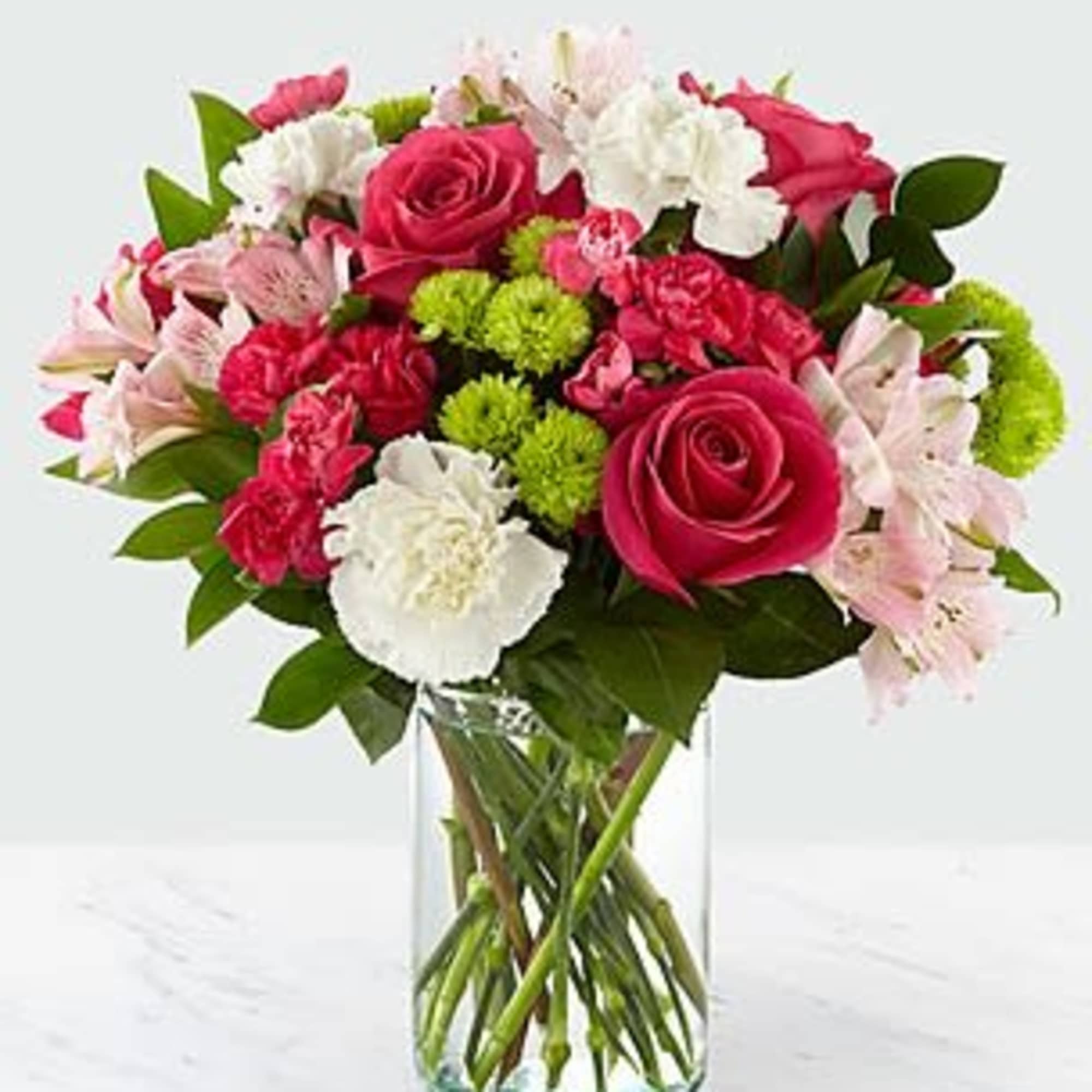 Bouquet of pink and white flowers in a clear glass vase