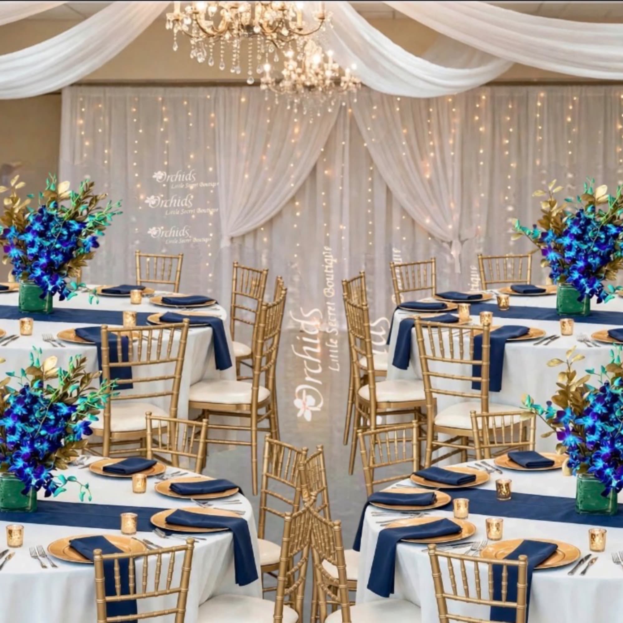 Wedding reception tables with blue floral centerpieces and gold chairs