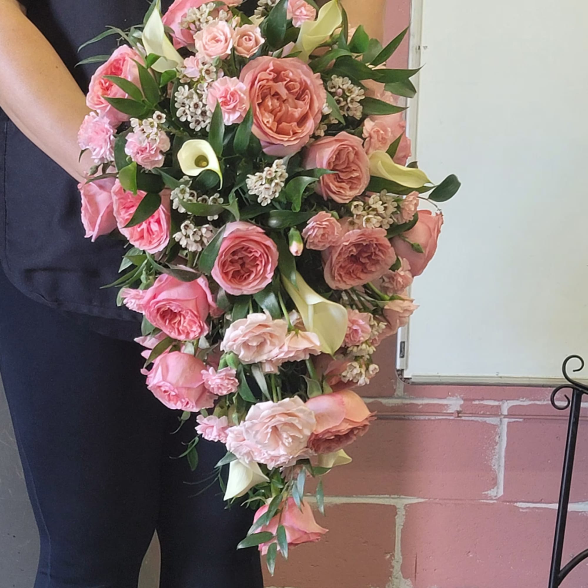 Large pink bouquet with roses, calla lilies, and greenery